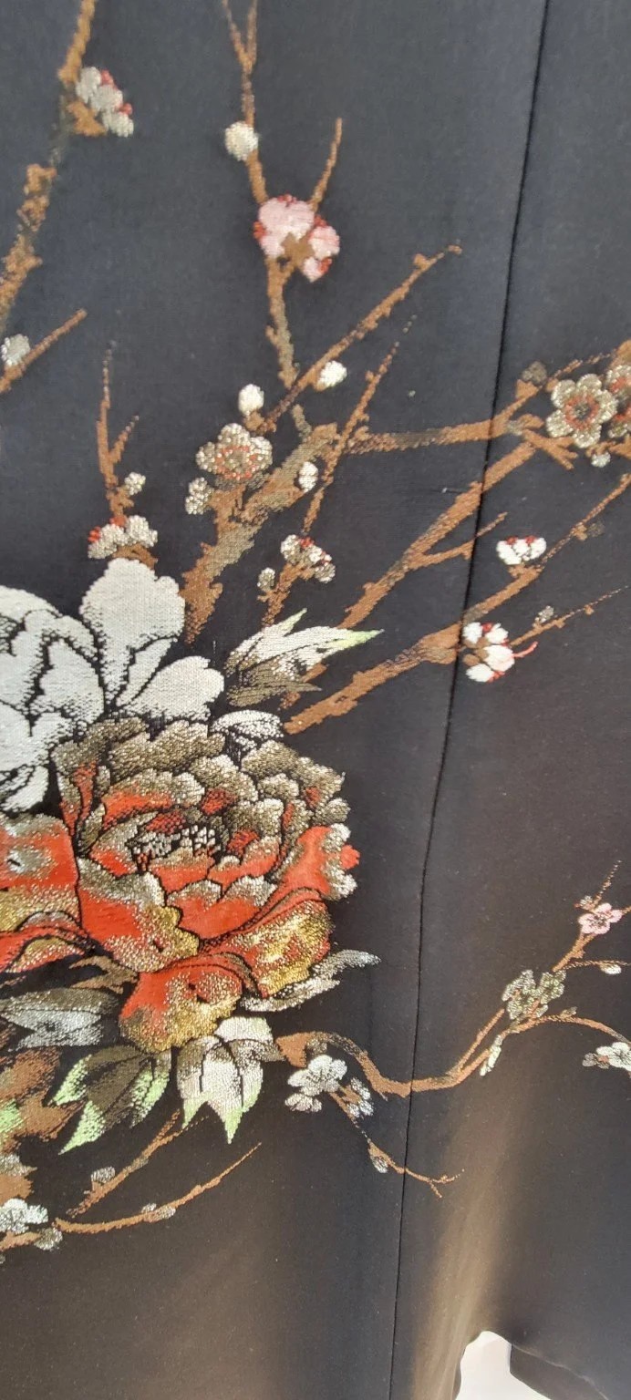 Detailed coral ivory and gold woven flowers and flowering branches on black Japanese silk