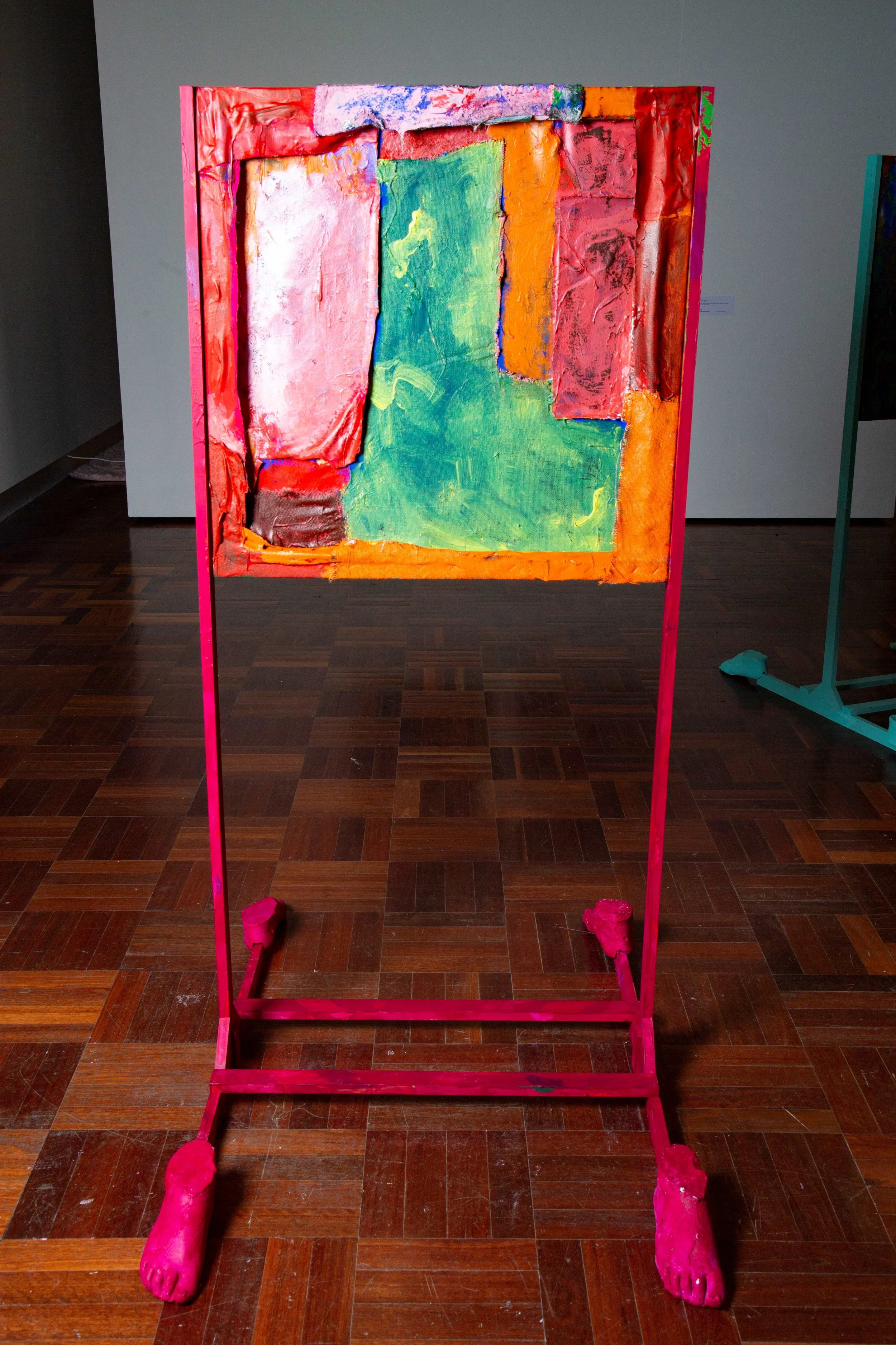 Abstract colorful painting on a frame stand in an art gallery.