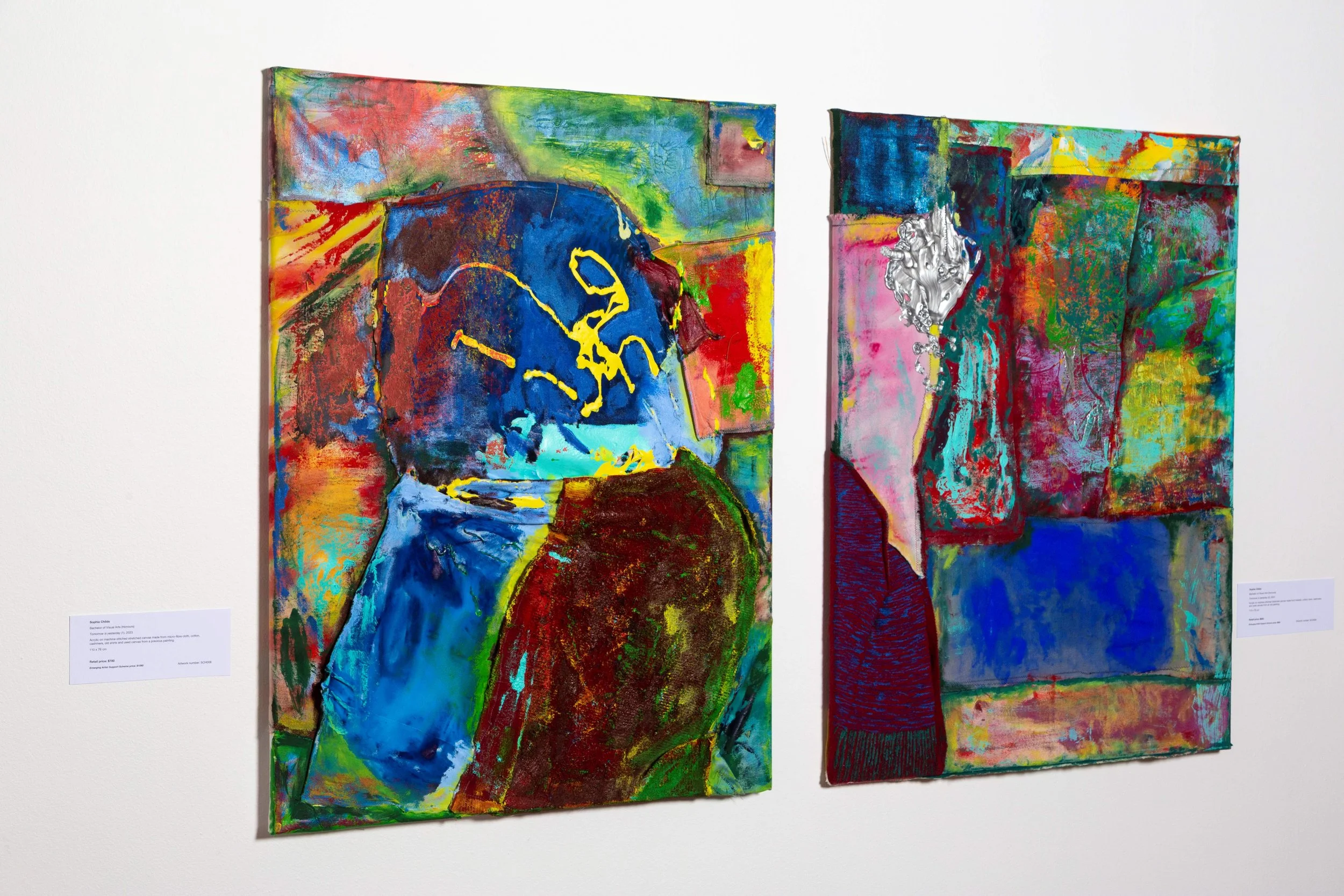 Two abstract colorful paintings on a white gallery wall.