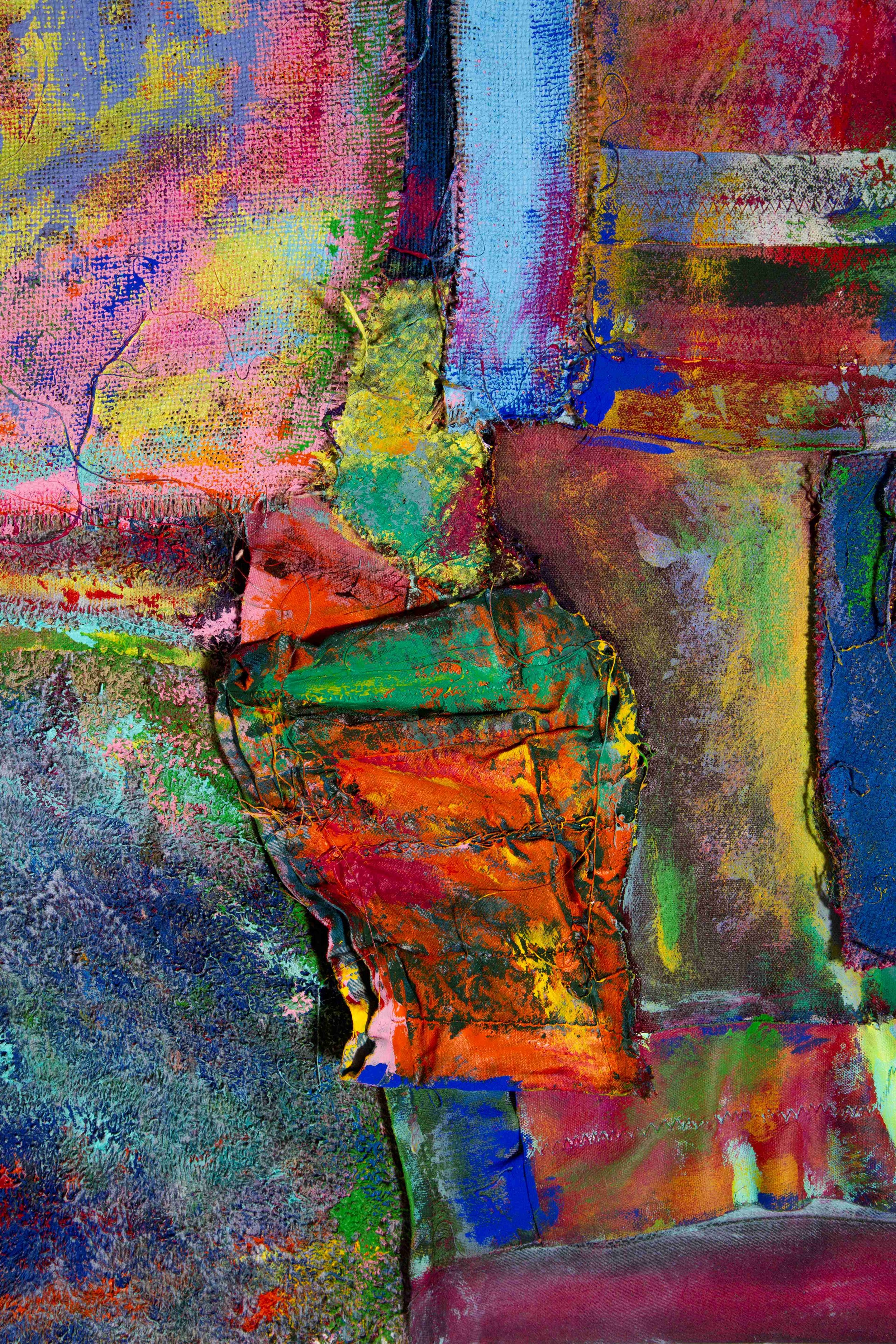 Close-up of a colorful, textured abstract artwork with various bright colors and stitched fabric pieces.