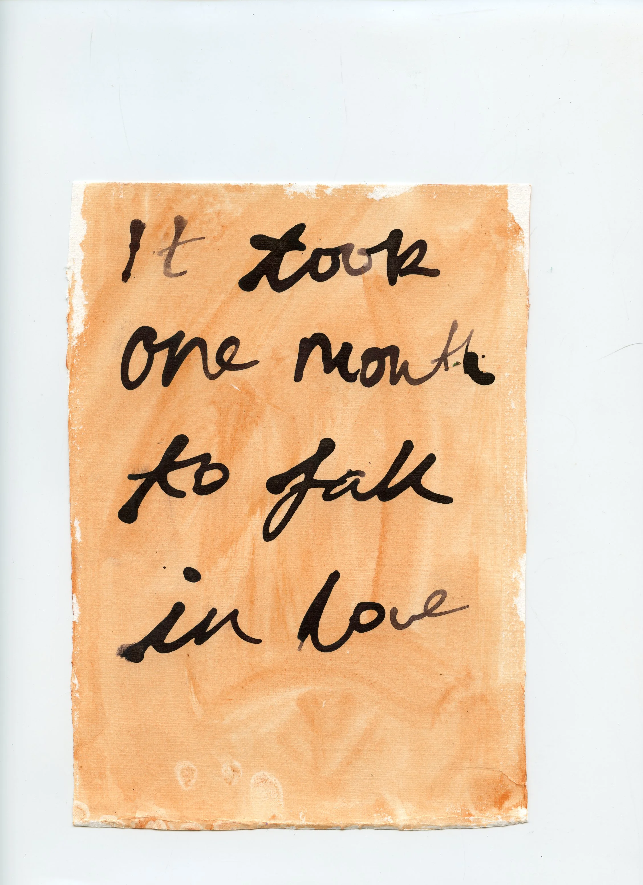 A handwritten note on orange paper reads, "It took one month to fall in love."
