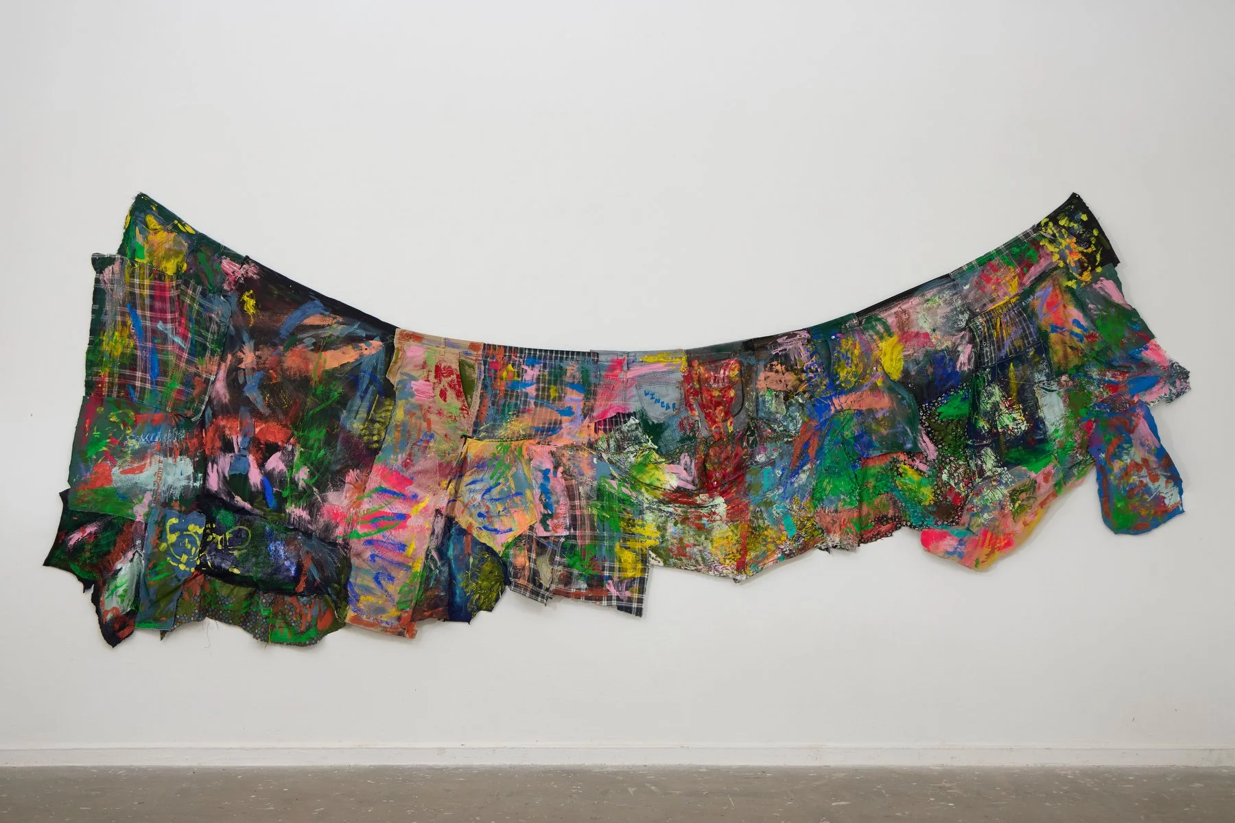 Pants, 2024, acrylic on machine-stitched textiles made from 11 pairs of paints, some skirt, a jumper and misc gifted textiles