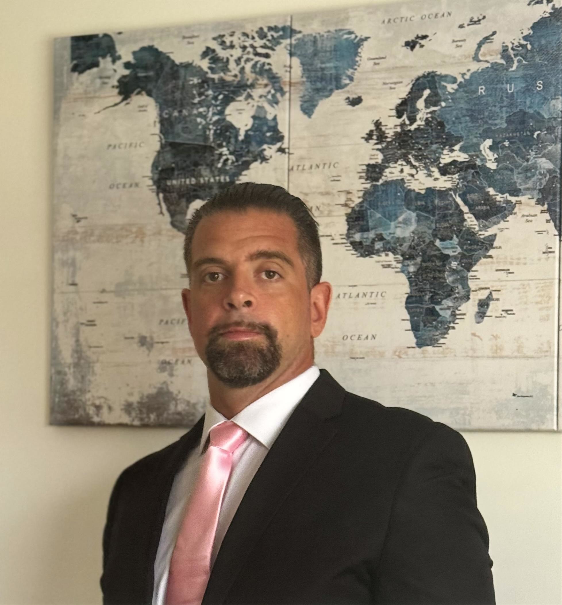 CPA Accountant posing with an International Global Map. enrolled agent willing to lower IRS tax liabilities.