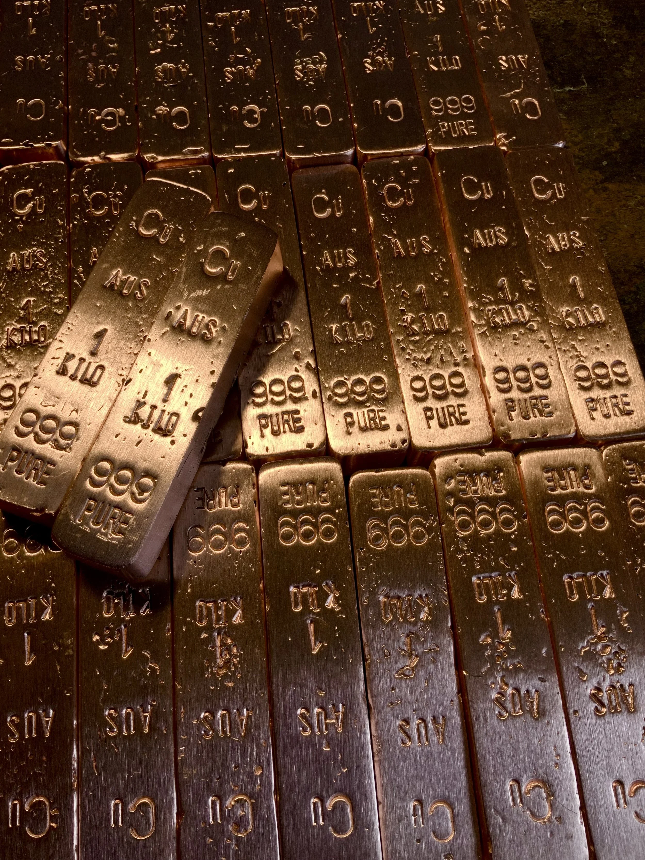 Batch of hand cast copper bullion bars 999 fine stacked Hinterland Bullion Co
