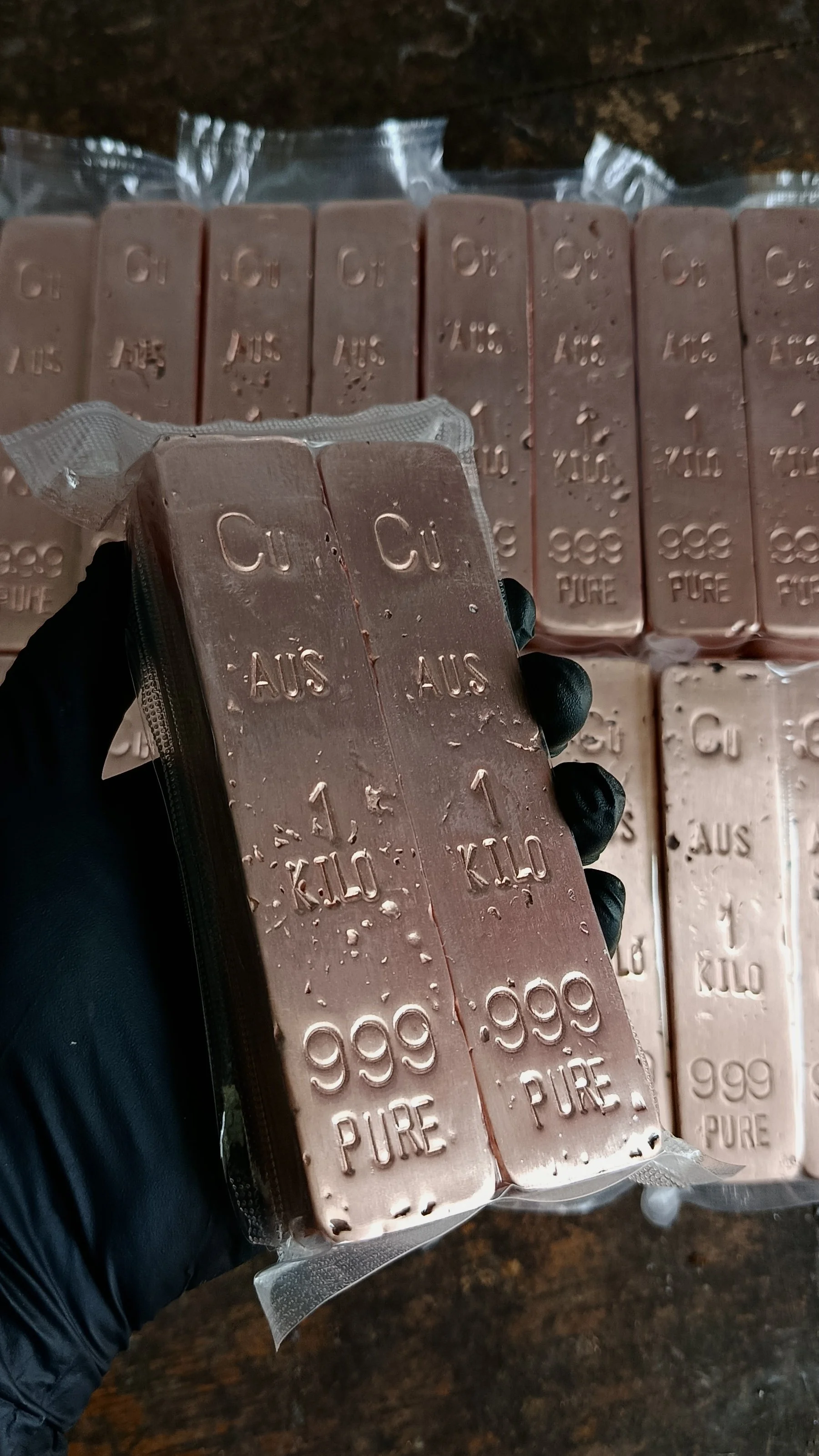 Hand holding 1kg copper bullion bar 999 fine Hinterland Bullion Co Australia