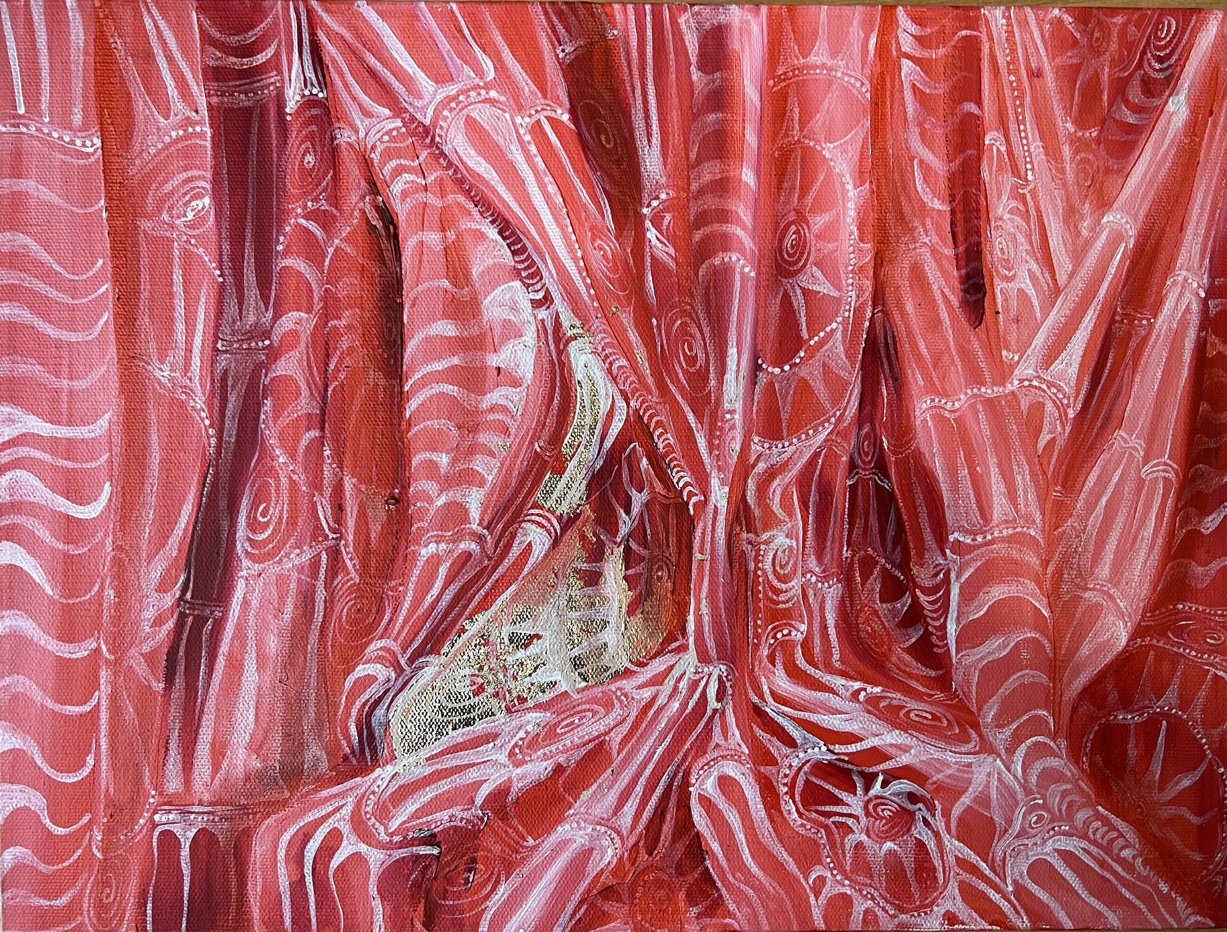Close-up of red and white patterned curtain with abstract designs.