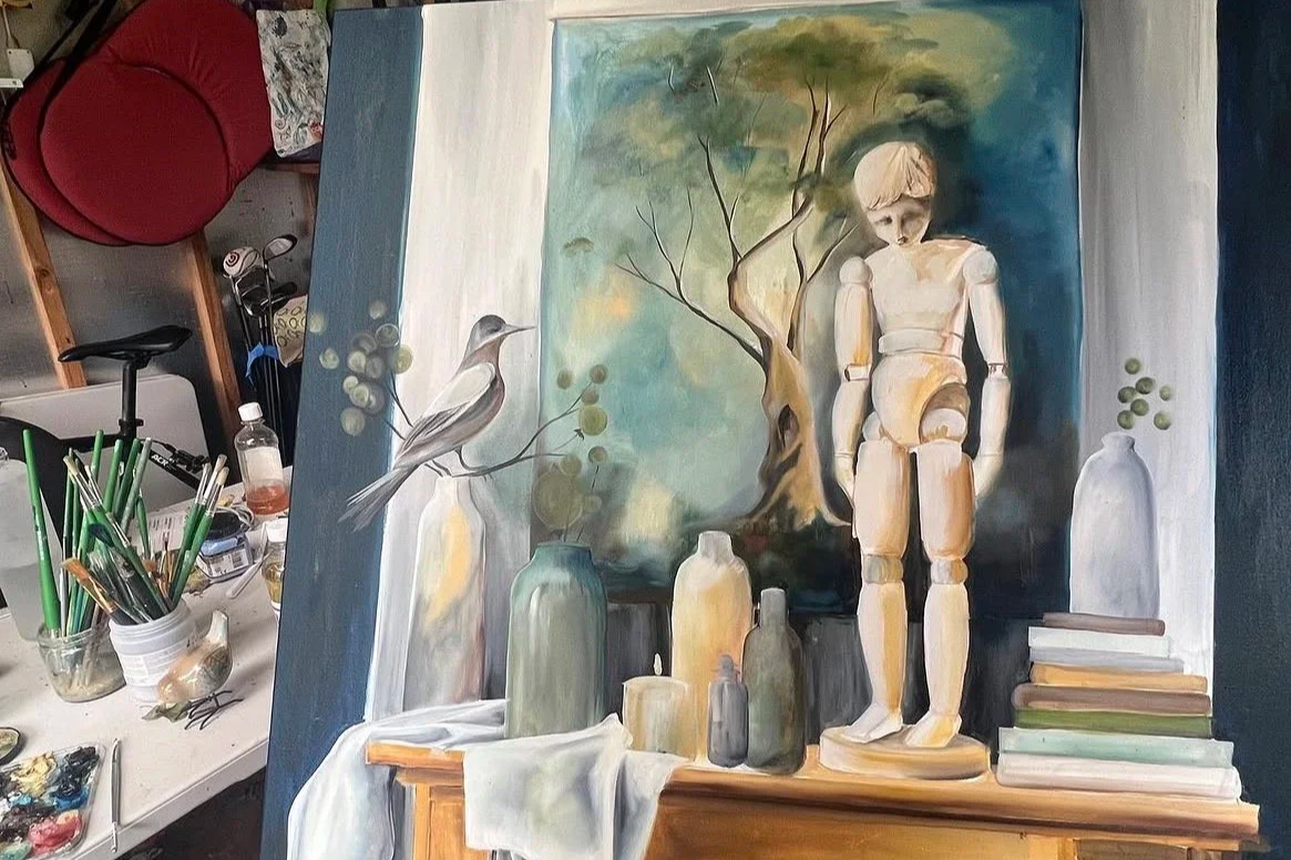 A painting showing a still life scene with vases, a bird perched on a branch, books, and a human-like mannequin figure in front of a landscape with a tree, created on a canvas with a background of blended colors.
