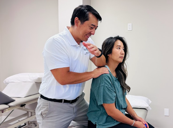 Grappling athlete receiving sports physical therapy shoulder assessment at a physical therapy clinic in Santa Ana, CA
