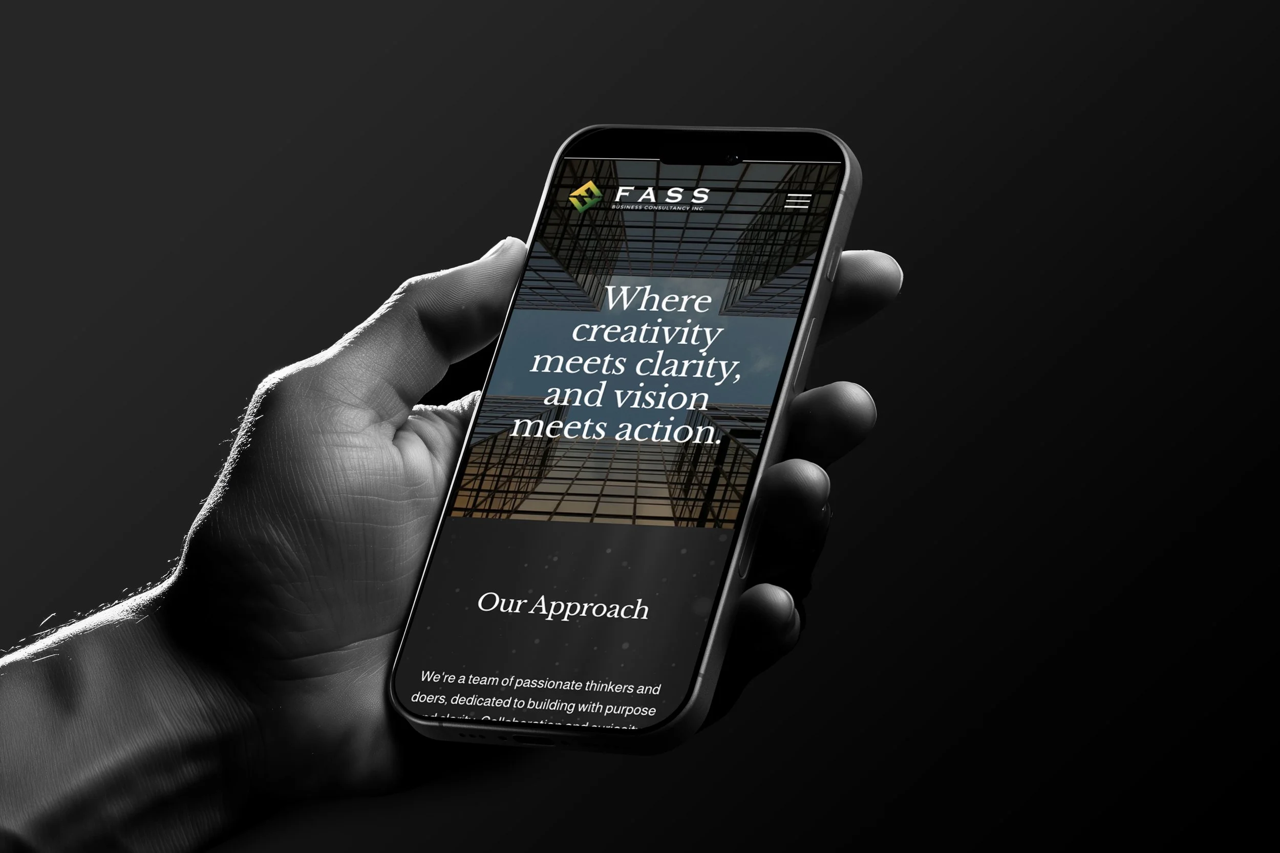 A hand holding a smartphone displaying a website with the logo 'FAS' and the text 'Where creativity meets clarity, and vision meets action.' on a dark background.