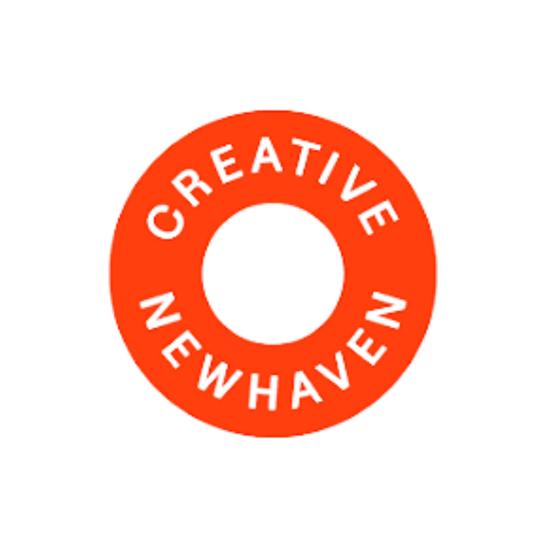 Creative Newhaven logo featuring the organisation name in black capitals arranged in a circle around a central hole on a bold red-orange disc