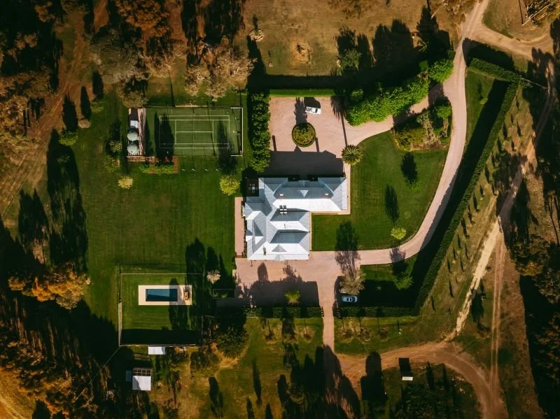Birdseye view of property showing gardens and landscaping with driveway.jpg