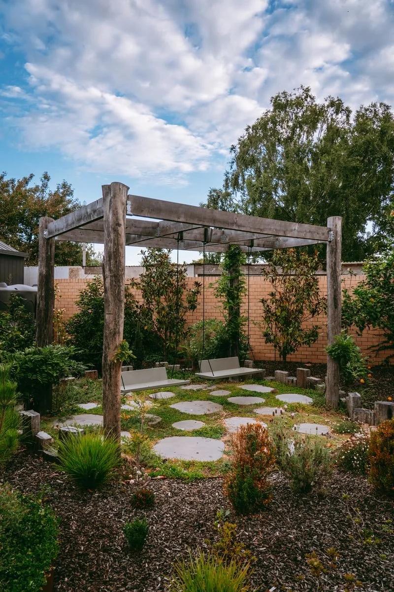 Pergola with swing seat garden design and pavers.jpeg