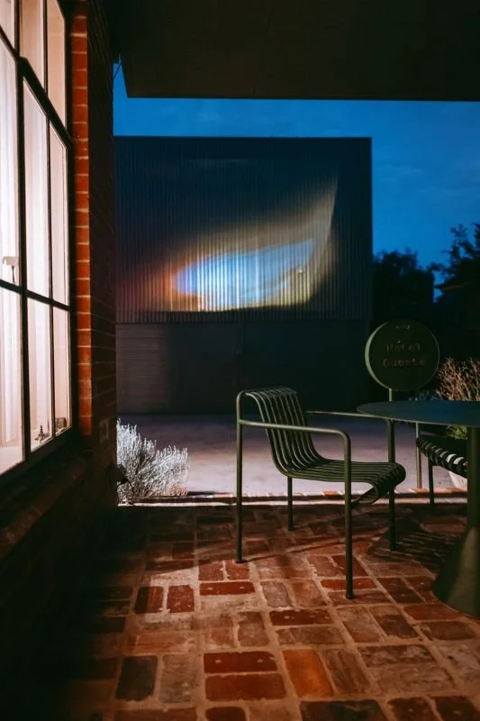 brick patio at night with garden furntiture and landscape garden.jpg
