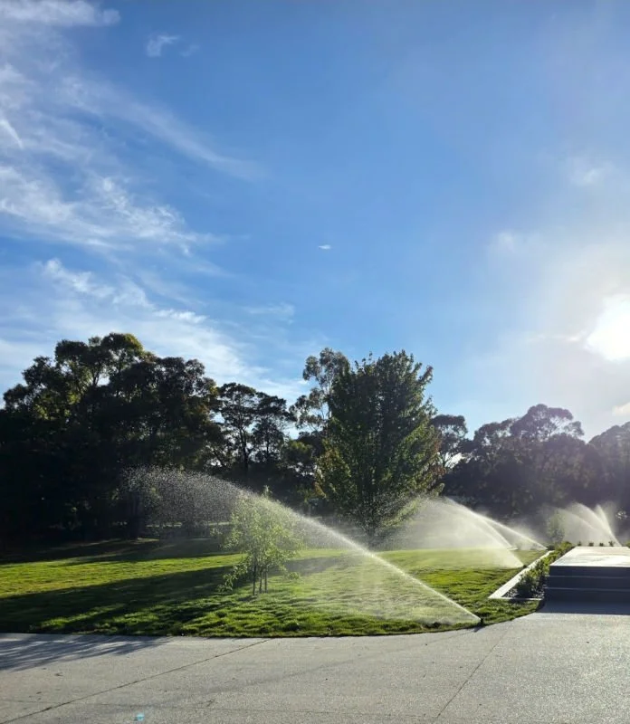 watering system irrigating grassed area