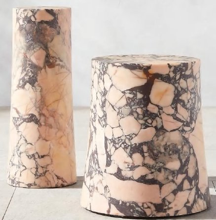 Two marble-patterned vases, one tall and cylindrical, the other short and rounded, placed on a light-colored surface against a plain background.