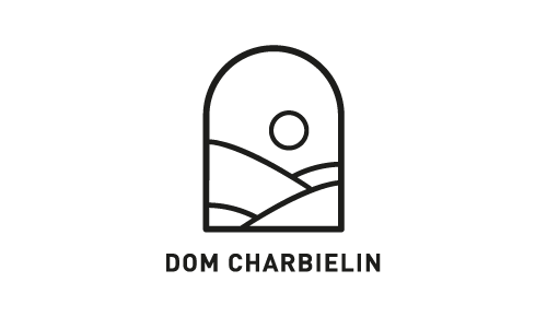 Logo with a stylized mountain and sun design, with the text "DOM CHARBELIN" below.