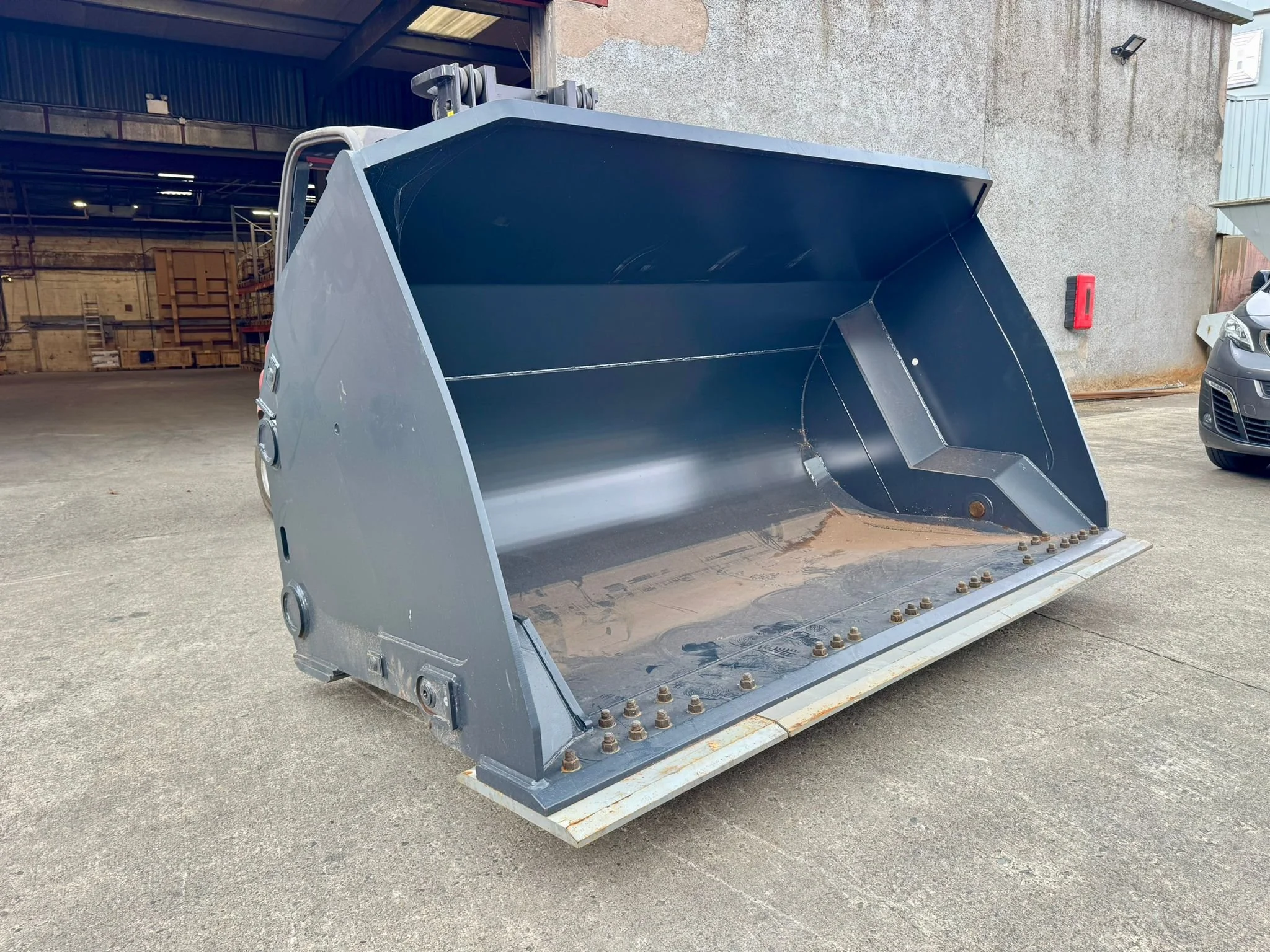 Large industrial bucket attachment for construction equipment.