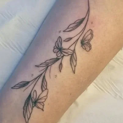 Tattoo of butterflies and leaves on skin fine line fineline minimal style 