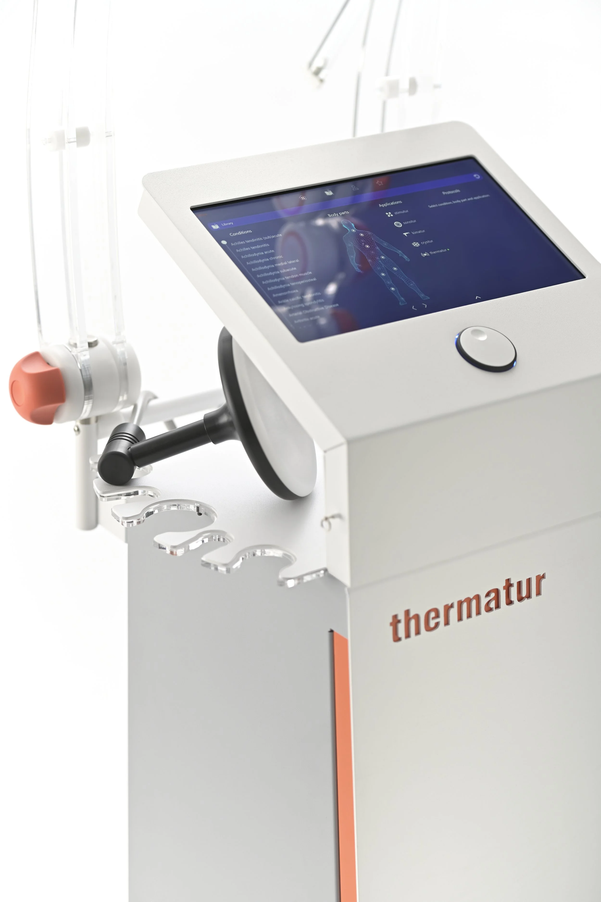 Medical device with a digital screen showing a human body diagram and various controls, labeled 'thermatur', used for therapeutic treatment.