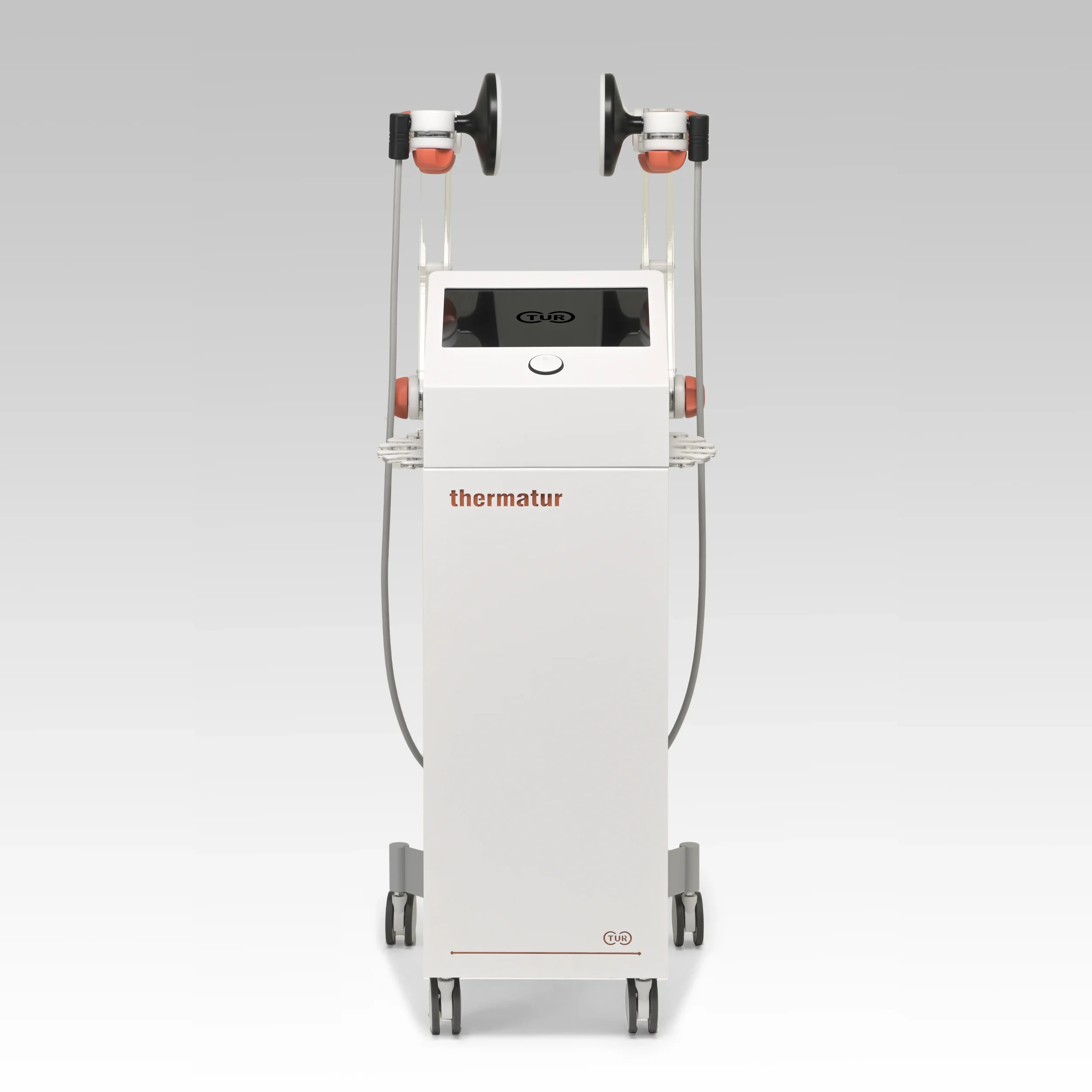 Medical device with two black circular display screens, orange and white components, a white base with the label 'thermatur', and a gray background.
