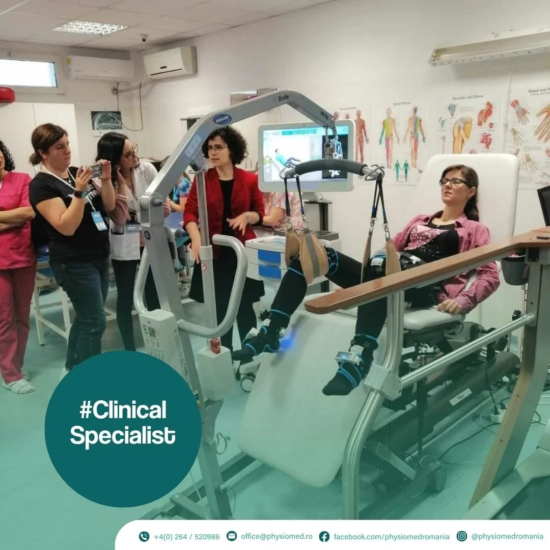 Medical training or demonstration in a clinical setting with a patient mannequin and healthcare professionals, and a group of observers taking notes or photos.