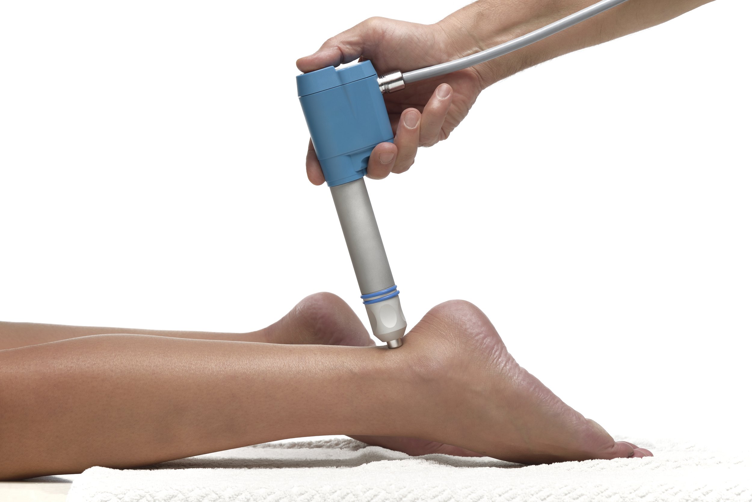 A person undergoing acupuncture treatment while lying on a white surface.