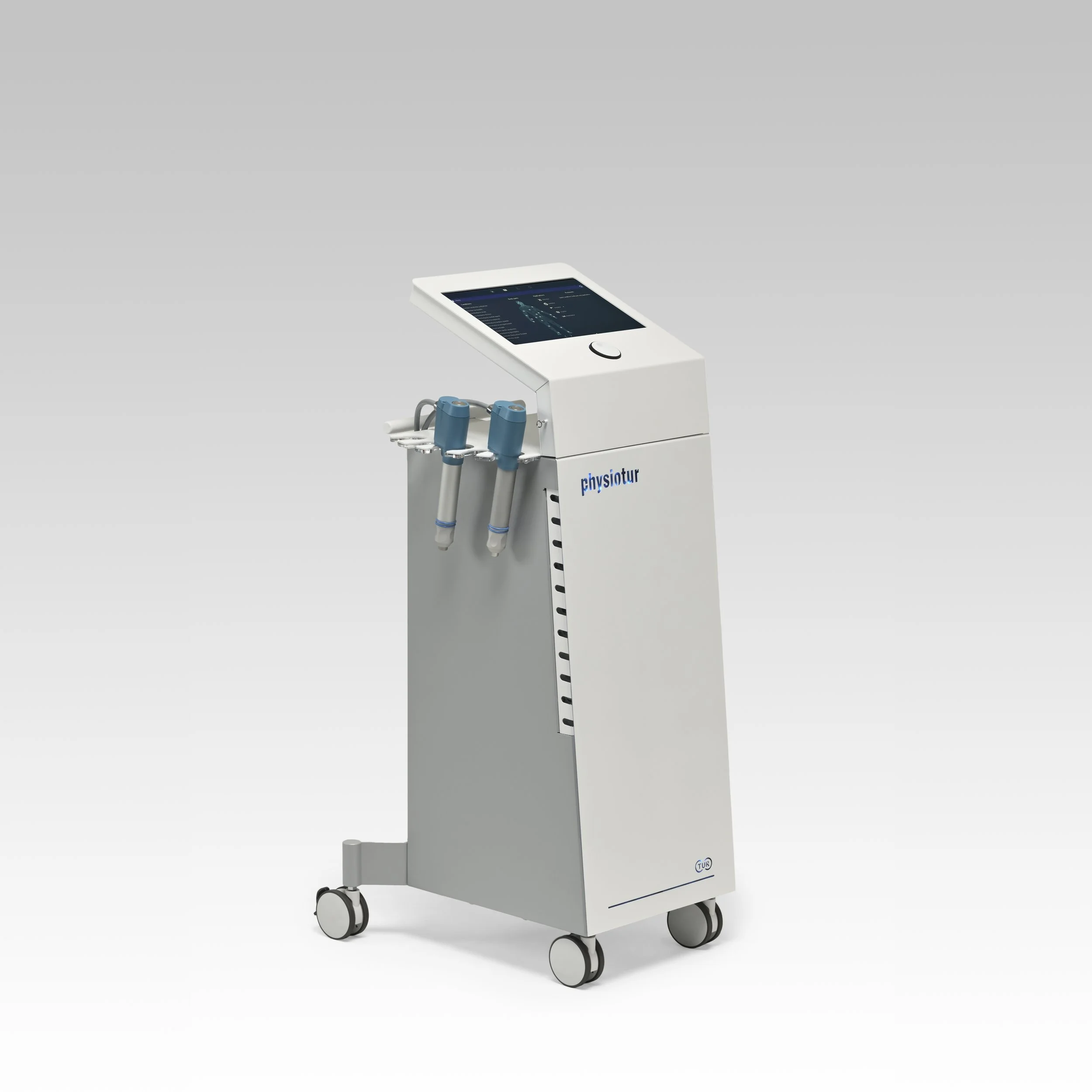 Medical device with a touchscreen display, labeled 'physiotur', connected to several hand-held treatment tools, on wheels