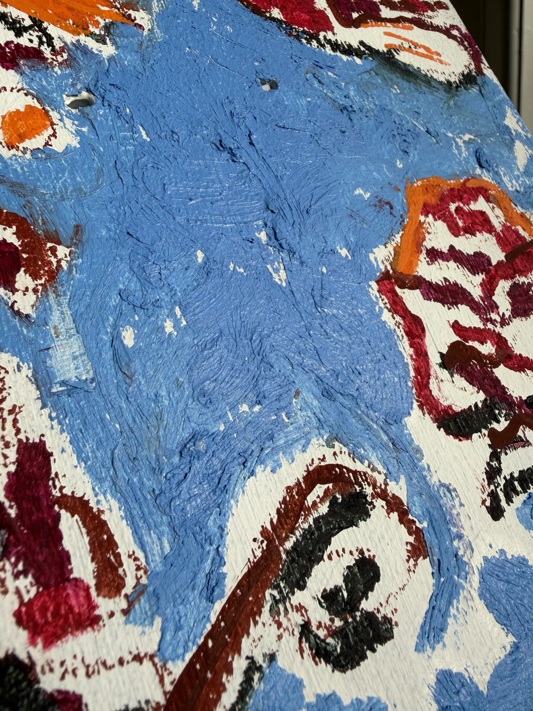 Oil stick painting of orange, burgundy and red wildflowers on a wooden skateboard deck, cornflower blue background