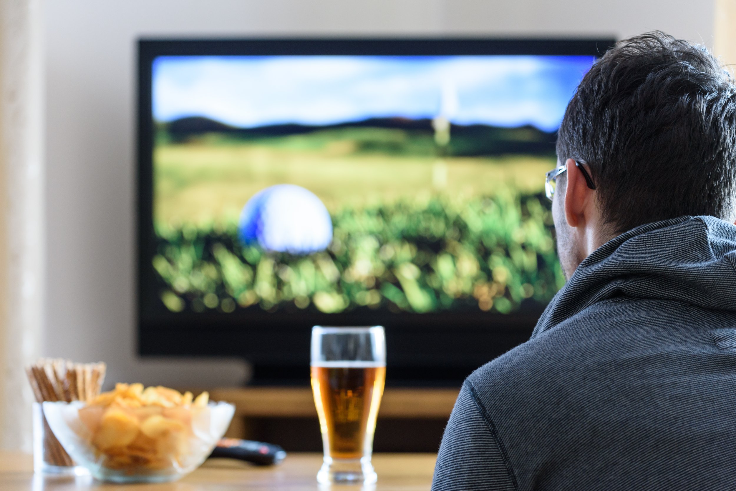 Golfer drinking beer watching The Open at Royal Troon