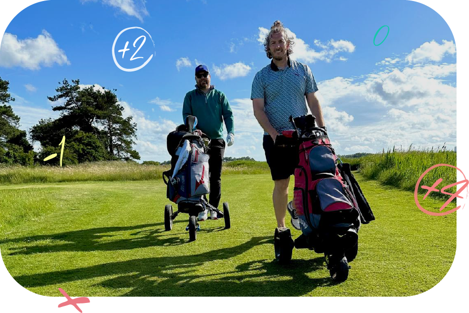 Two men walking on a golf course pulling golf carts with golf bags under a blue sky with some clouds and trees in the background.