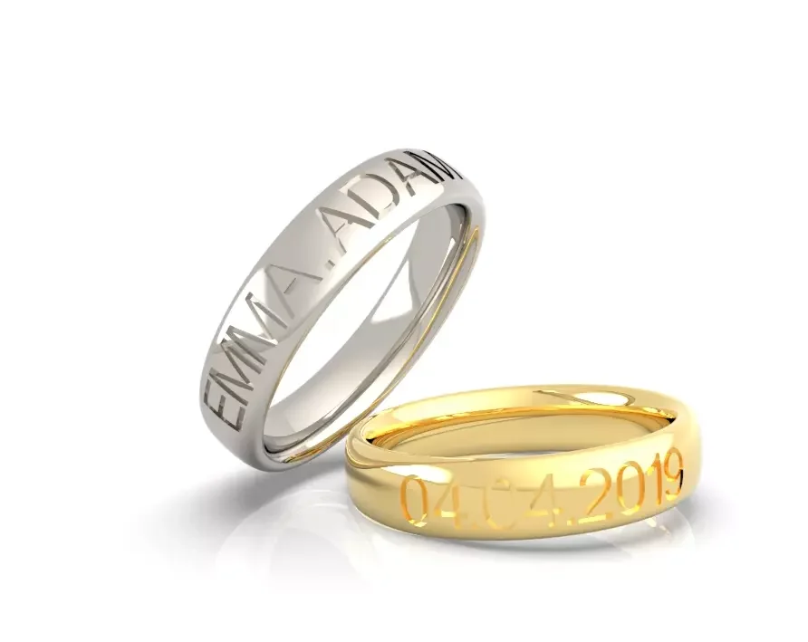 Deux alliances de mariage, une en or et l'autre en argent, gravées avec des dates et des noms.