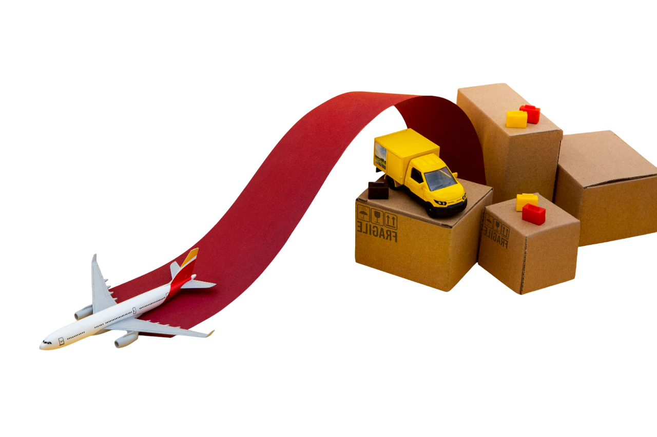 Toy airplane, toy vehicle, and stacked cardboard boxes on a red slide with a colorful ramp.