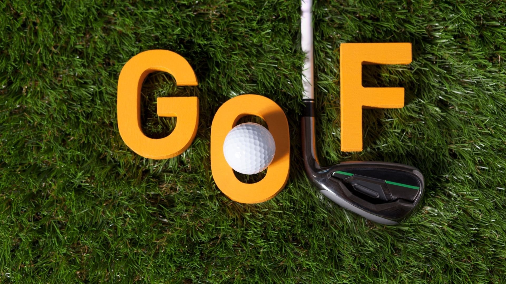 Golf course grass with orange letters spelling 'GOLF,' a golf ball, and a golf club.