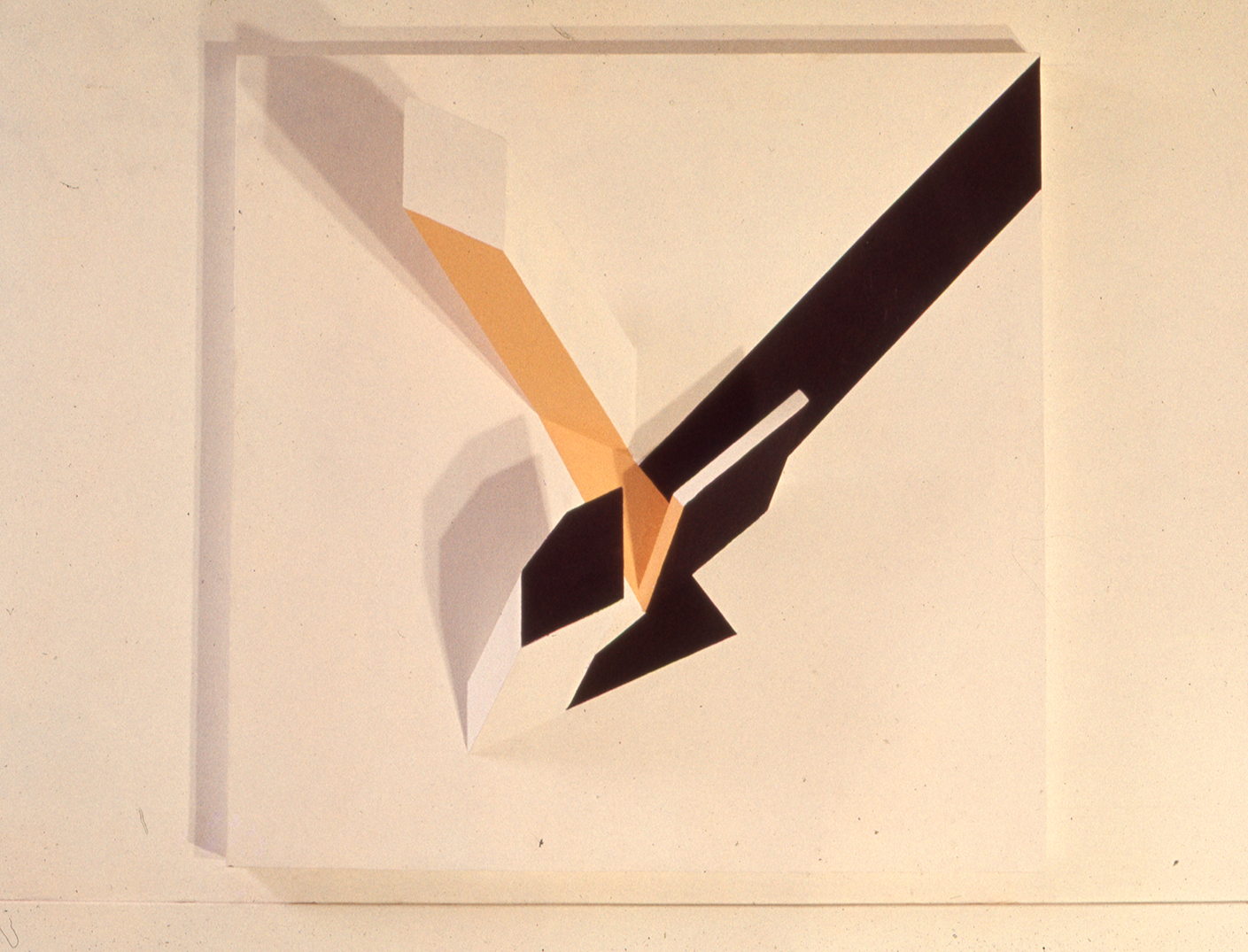 Abstract geometric artwork with sharp-edged shapes in black, white, beige, and orange on a beige background. Relief panel painted in emulsion on wood.