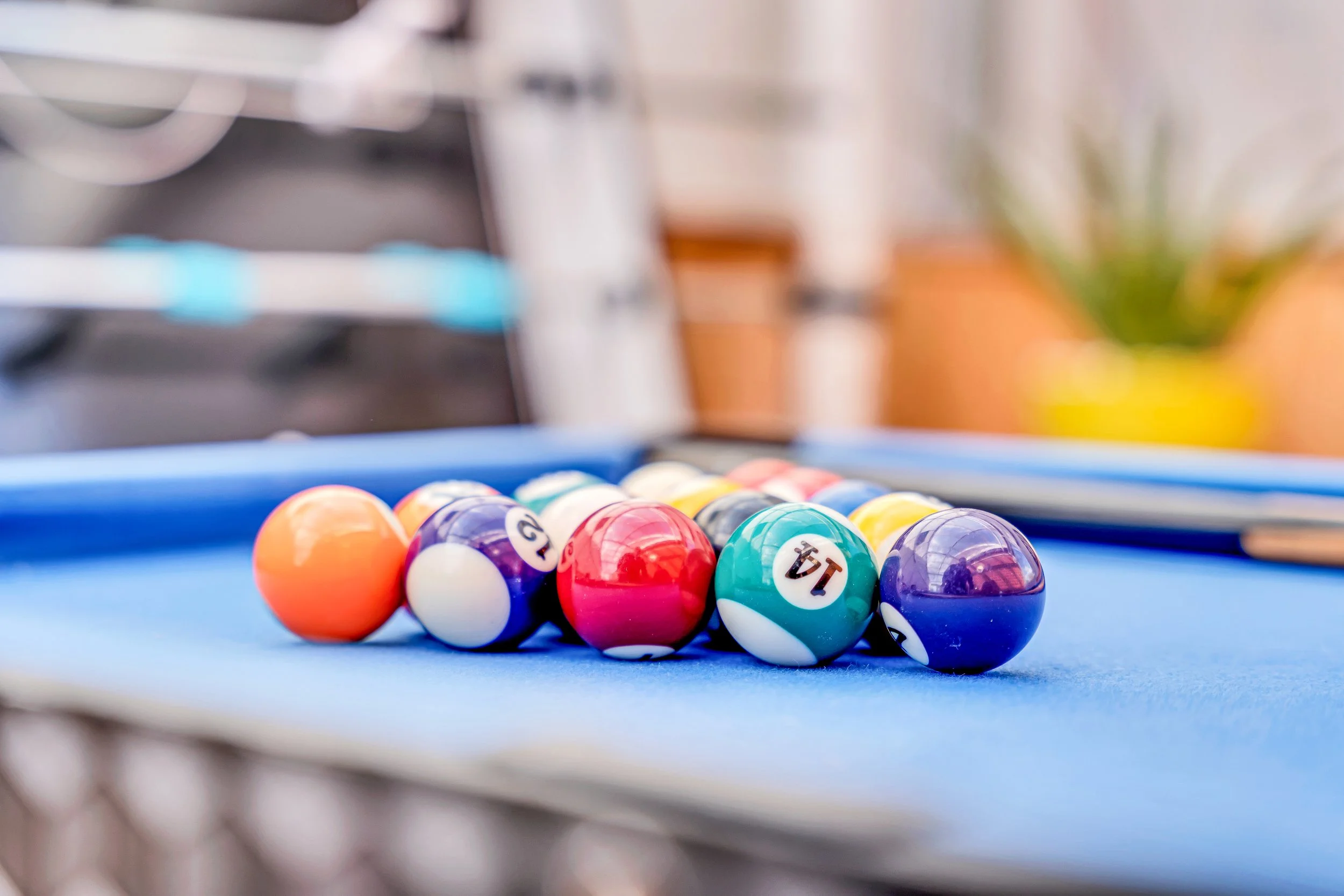 Pool balls arranged on a blue billiard table.