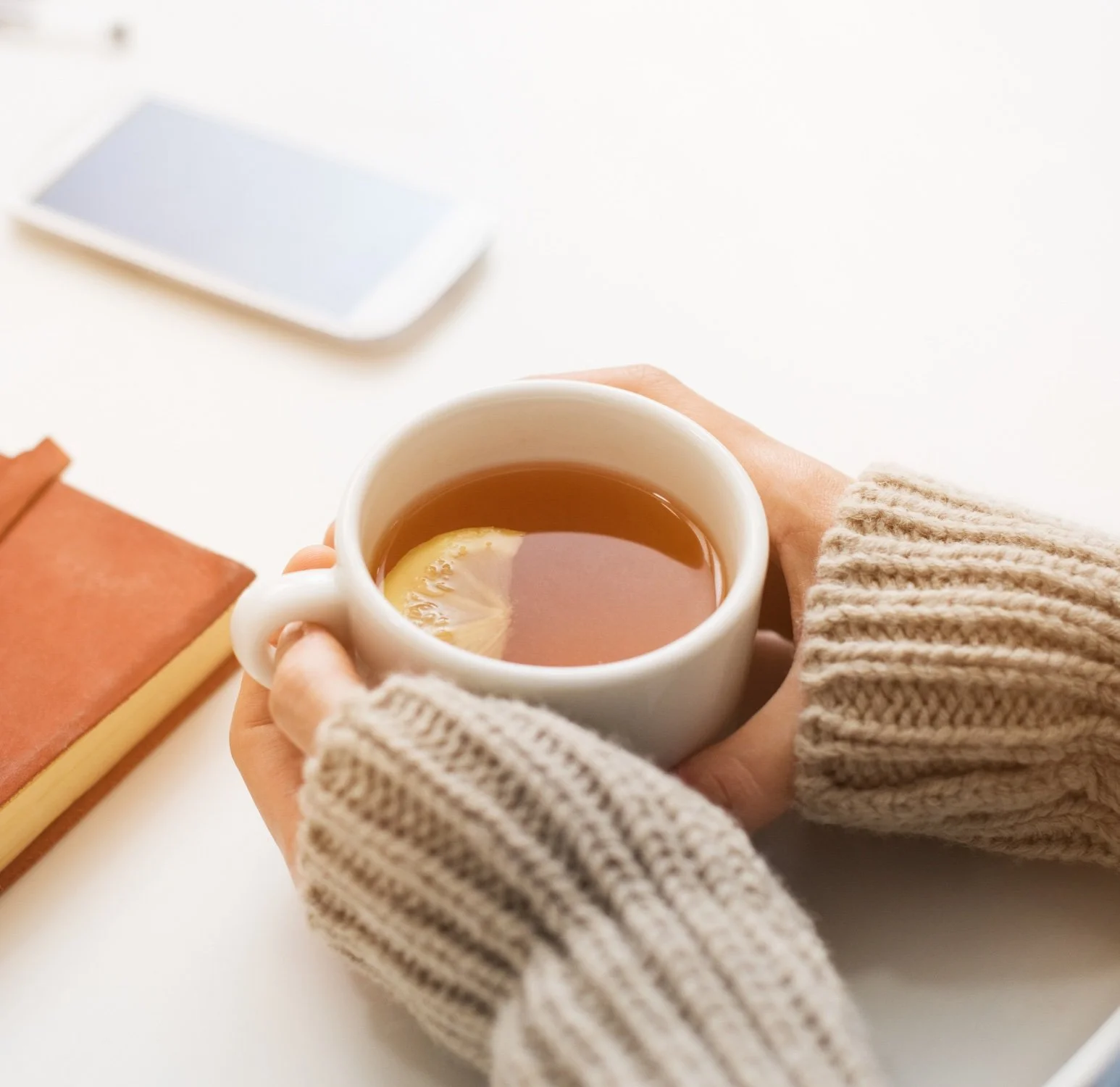 Woman holding a cup of tea.
