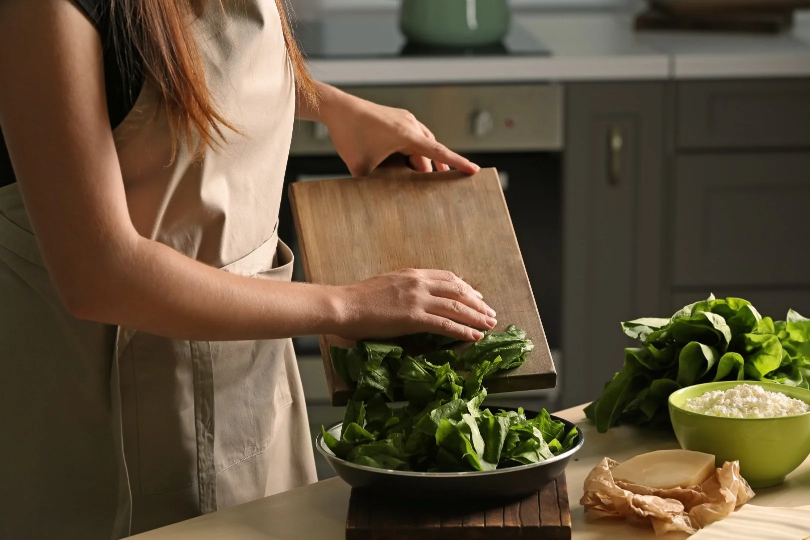 Woman during cooking a salad.