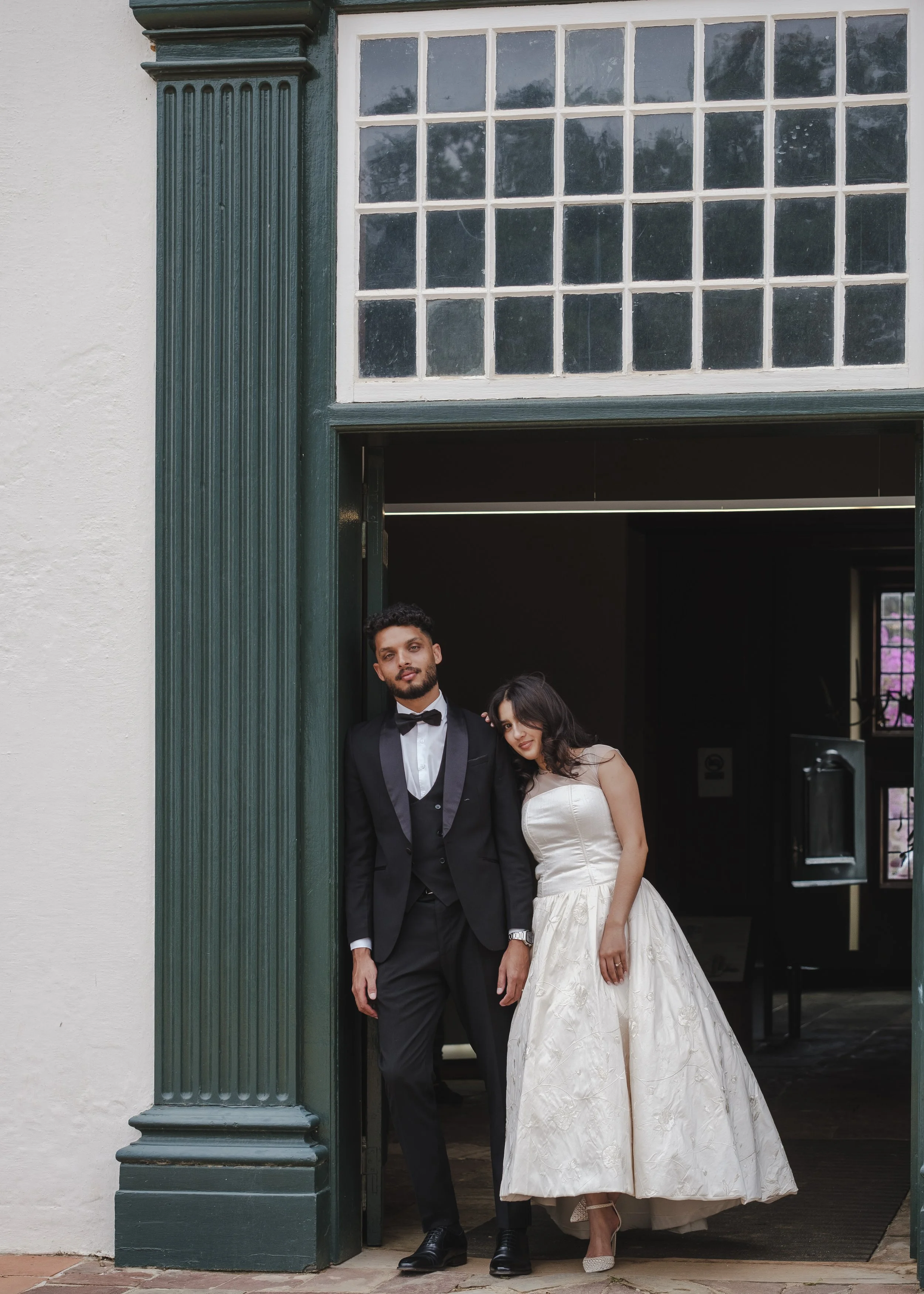 Bride and groom standing in doorway during wedding in Cape Town.
