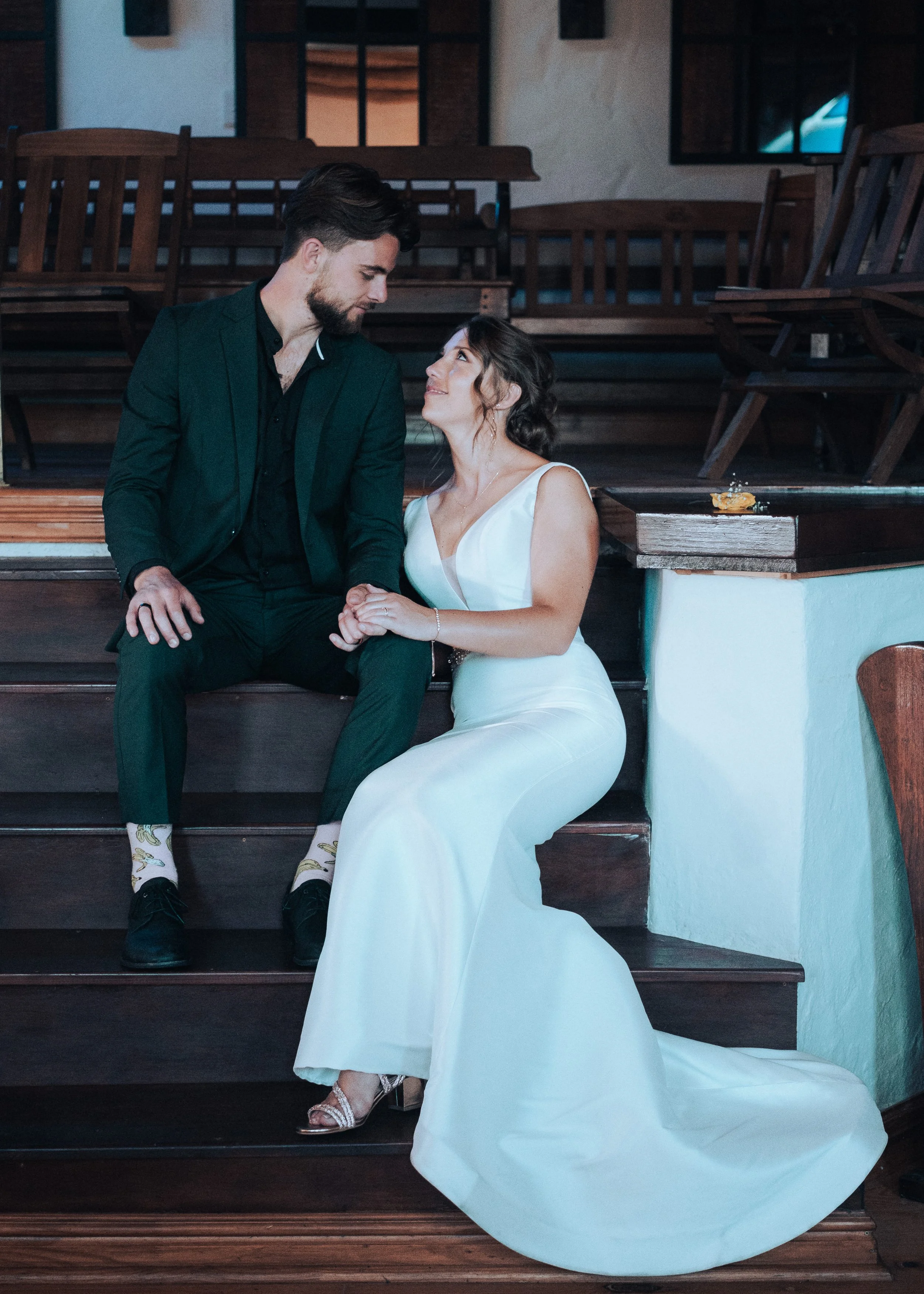 Bride and groom sitting together during wedding portraits