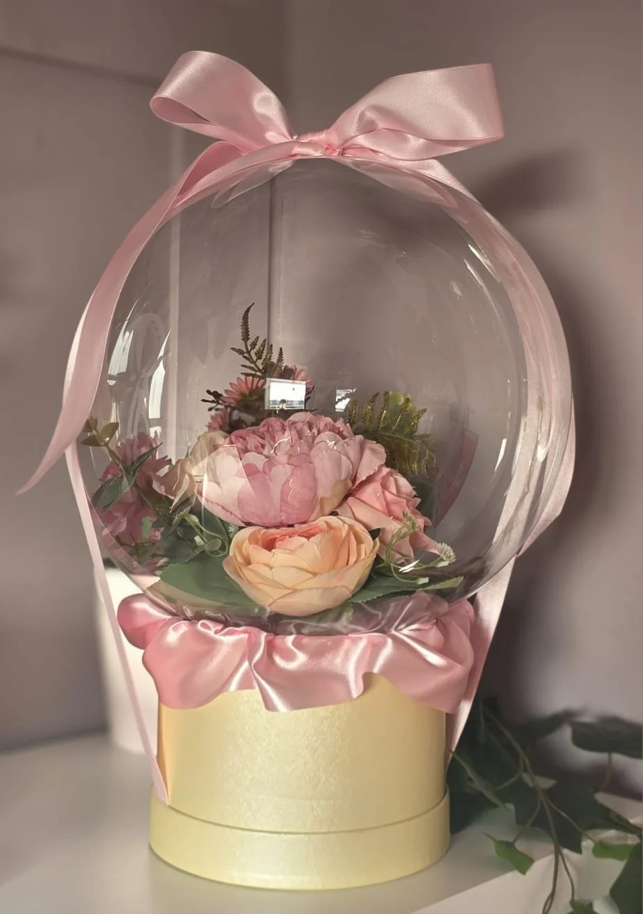 Personalised bubble balloon with artificial flowers inside, gift display created by B'Loonies in Hertfordshire.