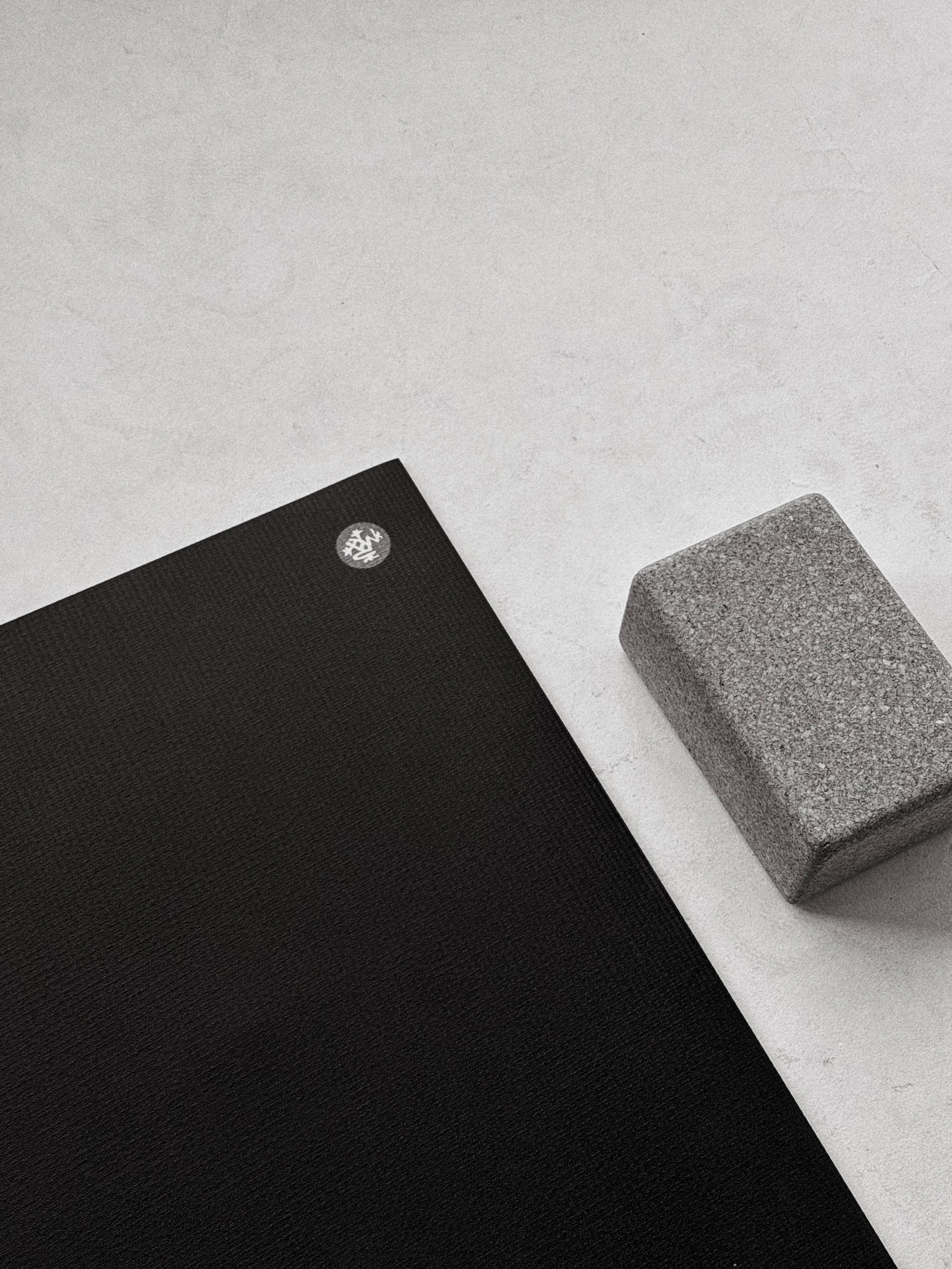 Jógová podložka a blok v minimalistickém klidném prostoru