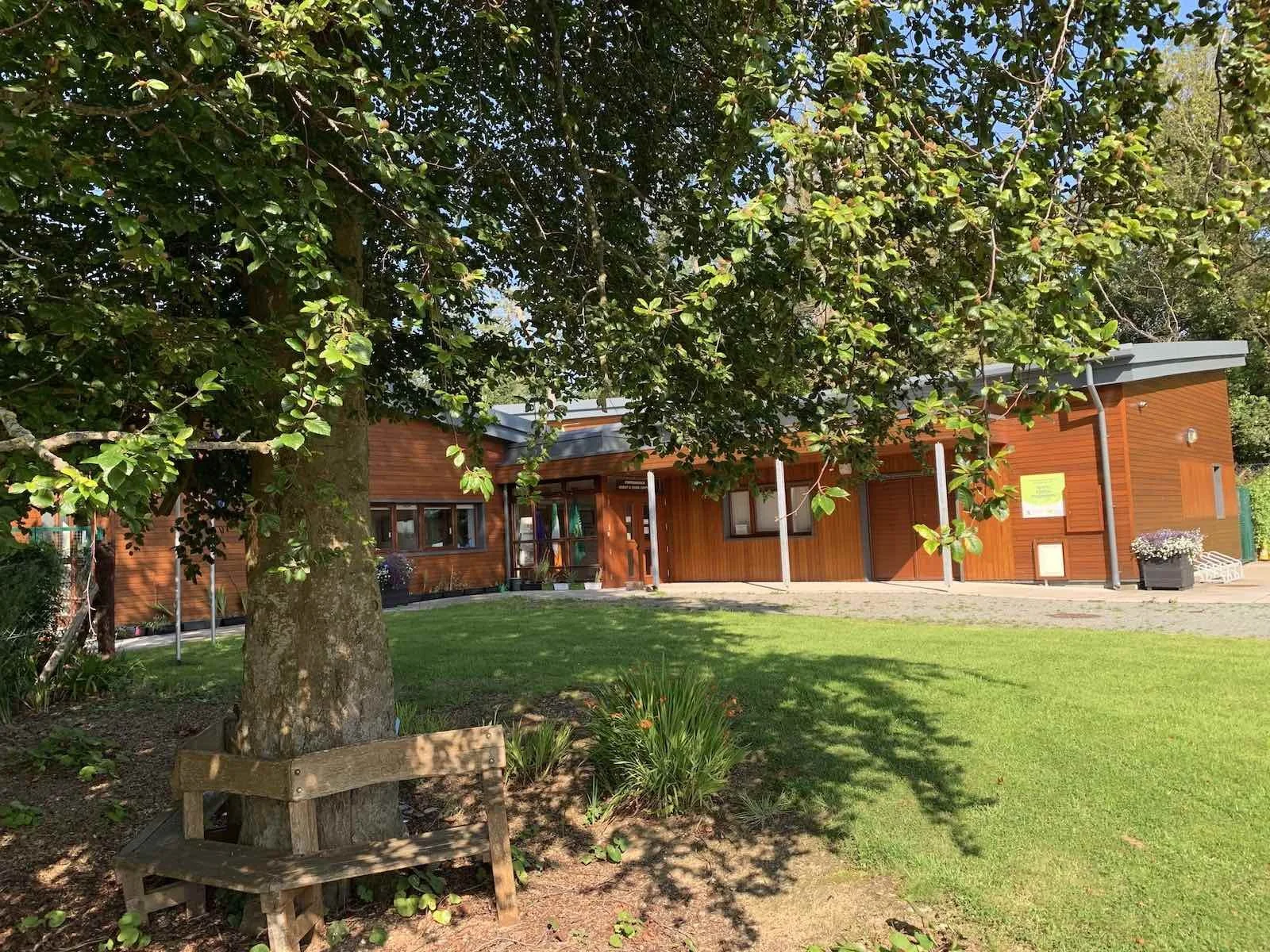 A picture of Portmarnock Scout & Guide Den in the sunshine with a tree in the foreground