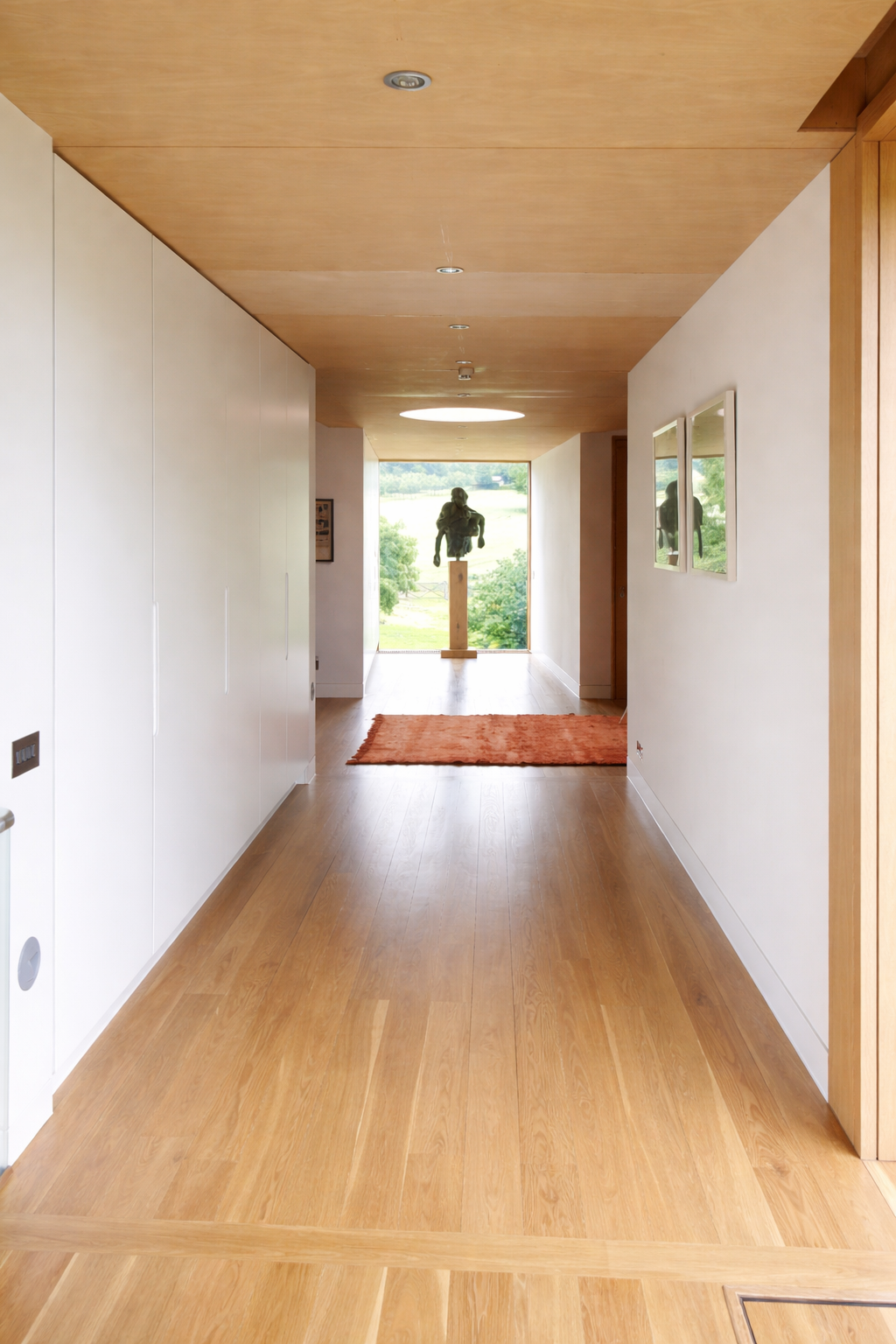 Dressing area with fitted wardrobes and glazed doors beyond