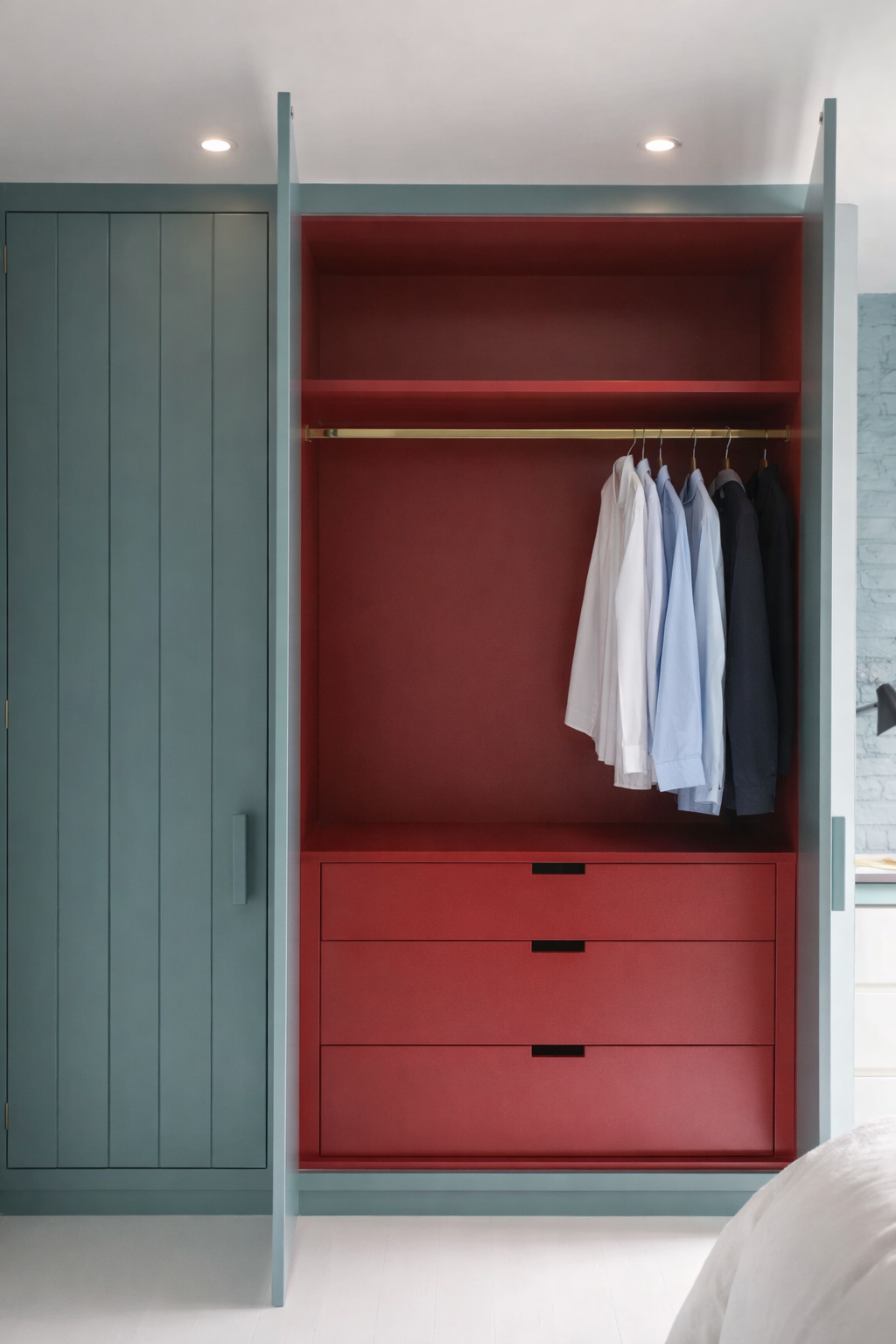 Fitted wardrobe with red interior, hanging rail and drawers