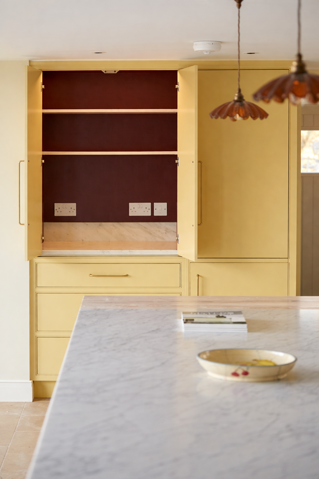 Tall painted kitchen breakfast pantry cabinetry with open doors & cararra marble worktop