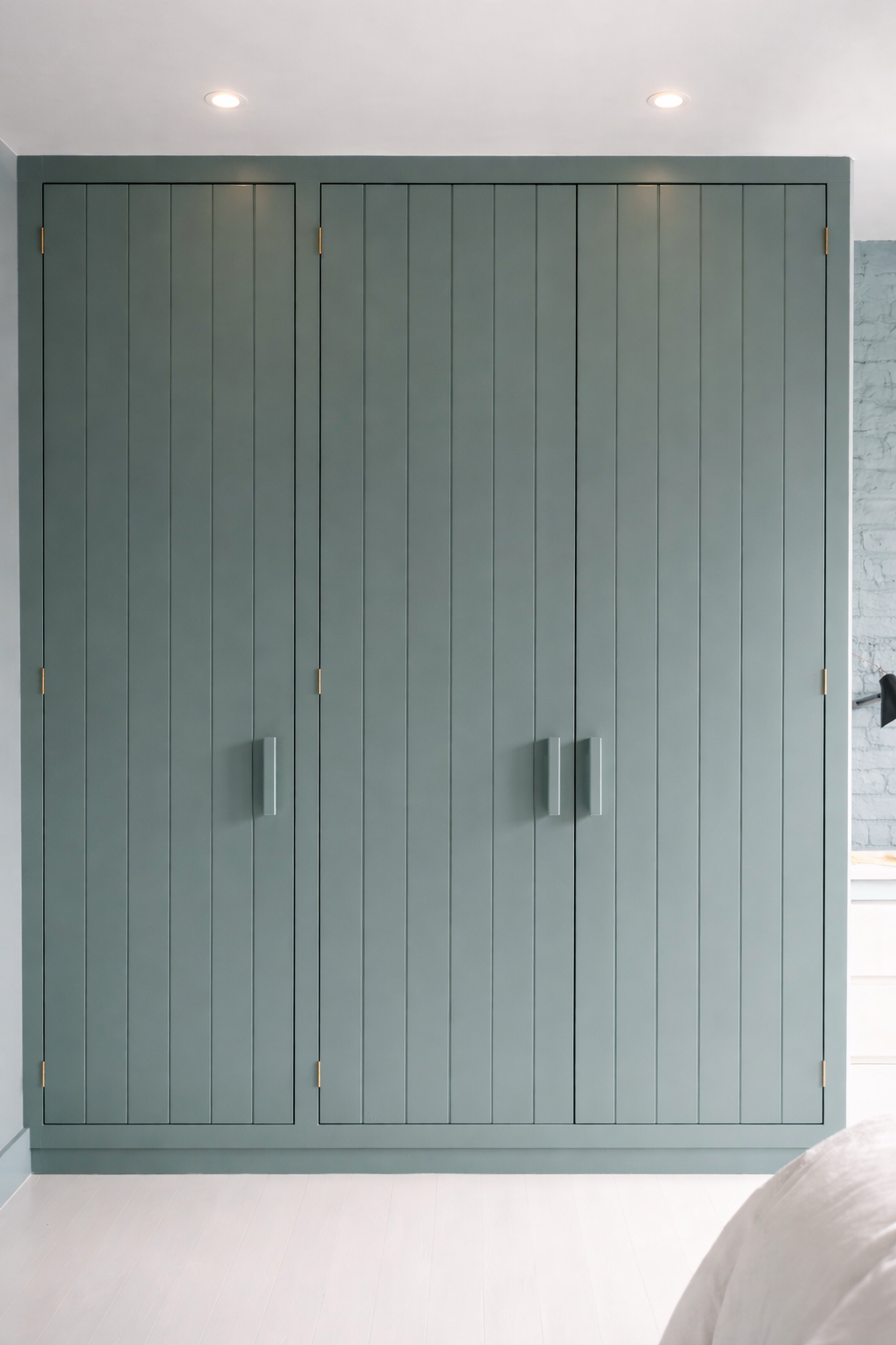 Painted fitted wardrobe with panelled doors