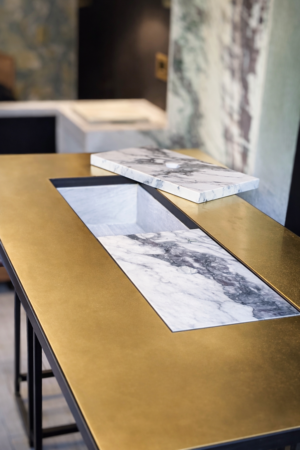 Brass table top with marble inset storage detail