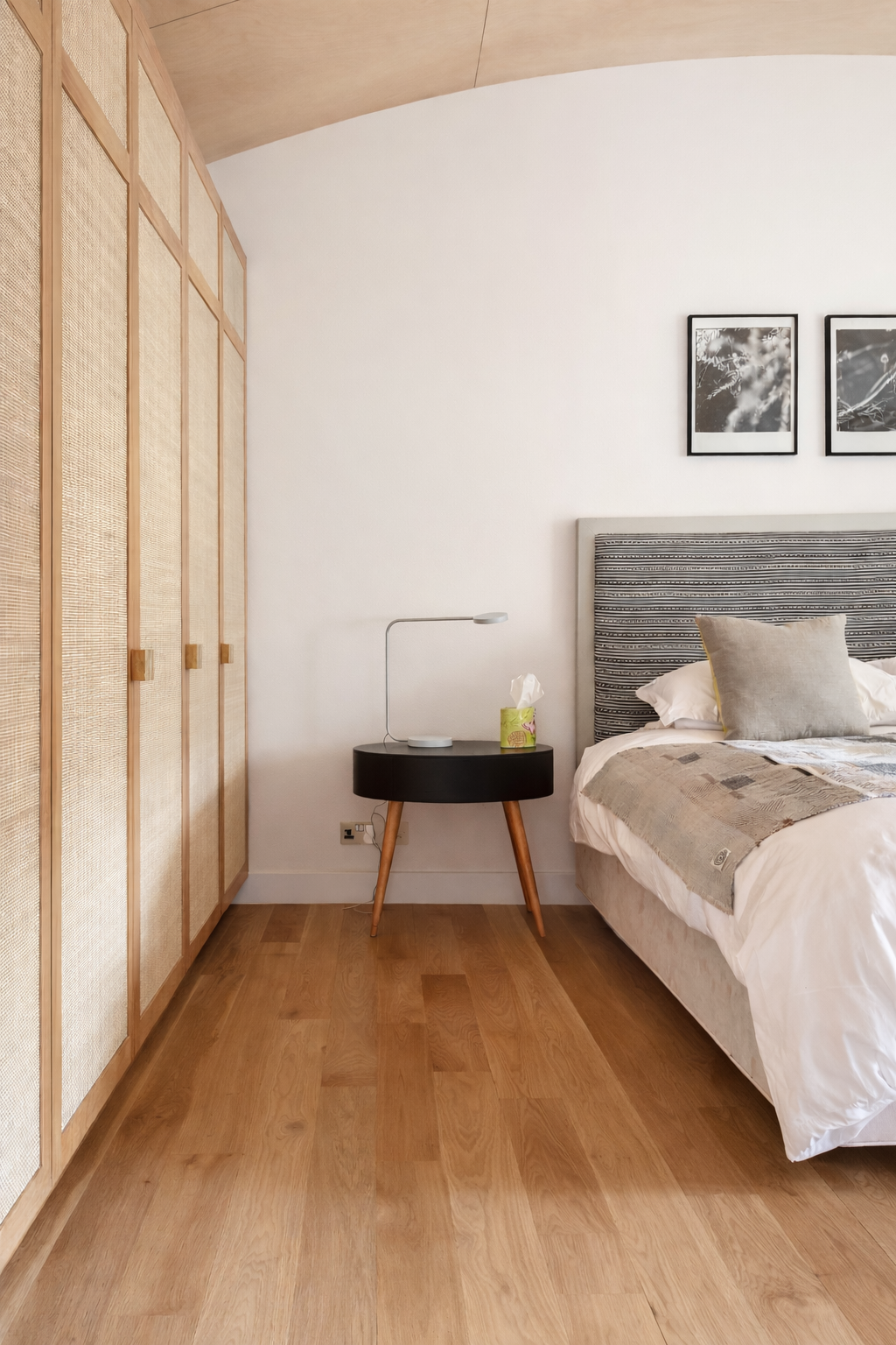 Bedroom wardrobe with woven panels beside bed