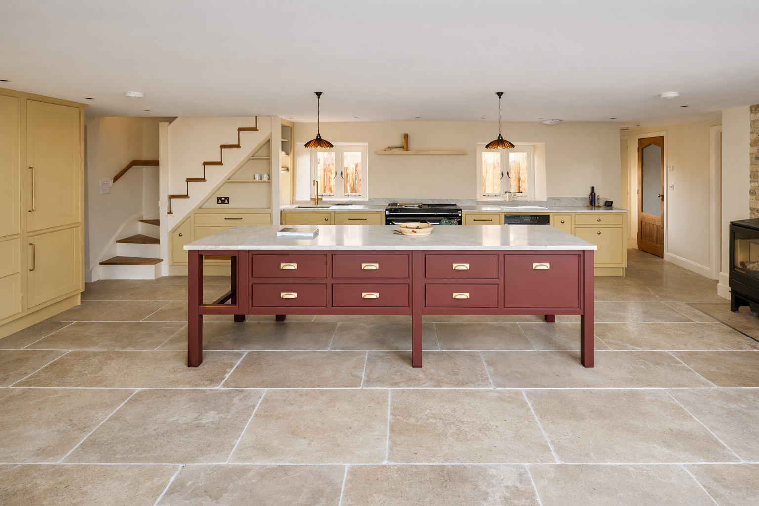 Full kitchen view with island, cabinetry and stair joinery