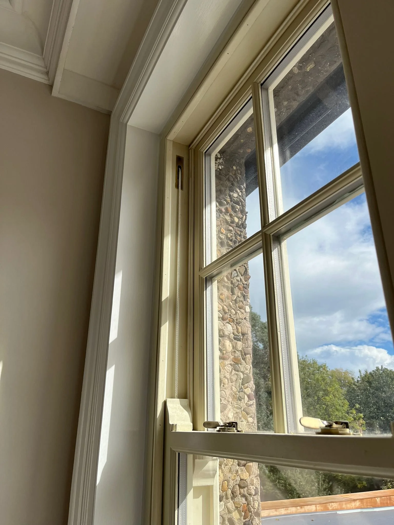 Traditional timber sash window with sliding panels in Sunderland home.